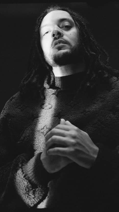 オズワルドボーテングのインスタグラム：「Musical genius and drummer, @Yussefdayes opened Black A.I with an unforgettable performance; setting the sonic tone of the show through the rhythm of his explosive grooves. Wearing a blue diamond, high peak, single breasted jacket with matching classic trousers, an oversized tank top and a statement knitted purple and red balaclava.  Thriving within a massive variety of musical genres, Dayes has collaborated with musicians from all corners of the music industry, melding everything from 70s funk to Senegalese percussion to jazz.  Whilst pushing musical boundaries, Dayes has developed a fluid sound that has inspired the new generation of musicians.」