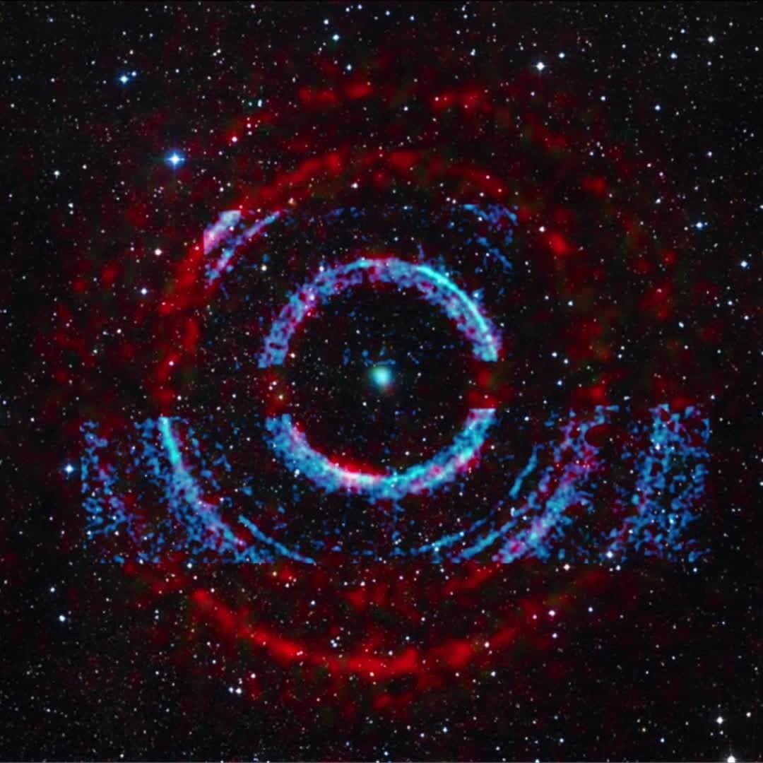 NASAのインスタグラム：「This new sonification turns “light echoes” from a black hole into sound.⁣⁣ ⁣⁣ Black holes are notorious for not letting light (such as radio, visible and X-rays) escape from them. However, surrounding material can produce intense bursts of electromagnetic radiation. As they travel outward, these busts of light can bounce off clouds of gas and dust in space, like how light beams from car’s headlight will scatter off of fog.⁣⁣ ⁣⁣ Located about 7,800 light-years from Earth, this system that contains a black hole with a mass between five and 10 times the Sun’s, that pulls material from a companion star in orbit around it. This material is funneled into a disk that encircles the stellar-mass black hole.⁣⁣ ⁣⁣ This sonification translates X-ray data from both @NASAChandraXray and Swift into sound. To differentiate between the data from the two telescopes, Chandra data is represented by higher-frequency tones while the Swift data is lower. In addition to the X-rays, the image includes optical data from the Digitized Sky Survey that shows background stars. Each star in optical light triggers a musical note. The volume and pitch of the note are determined by the brightness of the star.⁣⁣ ⁣⁣ Video description: Circular bands of red are surrounded by a starry background. Blue bands highlight the inner and lower portions of the black hole system. During the sonification, the cursor moves outward from the center of the image in a circle. As it passes through the light echoes detected in X-rays (seen as concentric rings in blue by Chandra and red by Swift in the image), there are tick-like sounds and changes in volume to denote the detection of X-rays and the variations in brightness.⁣⁣ ⁣⁣ Credit: (X-ray) Chandra: NASA/CXC/U.Wisc-Madison/S. Heinz et al.; Swift: NASA/Swift/Univ. of Leicester/A. Beardmore; (Optical/IR) PanSTARRS; (Sonification) NASA/CXC/SAO/K.Arcand, SYSTEM Sounds (M. Russo, A. Santaguida)⁣⁣ ⁣⁣ #NASA #Chandra #BlackHole #BlackHoleFriday #Sonification #Space #Sounds」