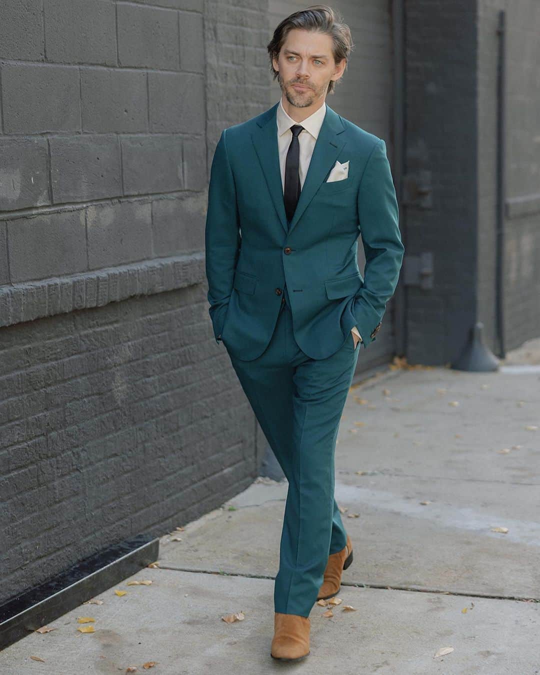 トム・ペインのインスタグラム：「THE OUTFIT: This suit has travelled the width of America 3 times and crossed the Atlantic once. I originally contacted @zegnaofficial way back in 2019 to create a custom suit and shirt. The first one I have ever had from scratch. Luckily the color worked perfectly for Autumn as it was originally meant for spring! When the pandemic hit we moved back to LA and I crossed my fingers the suit would someday turn up. I contacted the NYC store months later when things opened back up and it was there. I had it sent to LA for final fitting and then took it back to NYC for the wedding! I love the monogrammed pocket square and the shirt also has my initials stitched on 😆 The boots are the most comfortable I have ever owned. I needed a little extra heel to match Jennifer and saw these in the window of @balmain in New York. I had spent the morning trying on much more painful leather shoes and when I these on they fit like a glove with no pain at all. Instant purchase!」