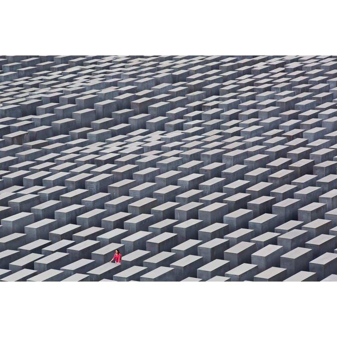 Gerd Ludwigさんのインスタグラム写真 - (Gerd LudwigInstagram)「The Holocaust Memorial in Berlin, officially known as the Memorial to the Murdered Jews of Europe, is a seemingly endless alignment of concrete blocks and serves as a poignant reminder of the atrocities of the past.   Designed by architect Peter Eisenman and Buro Happold and seen here from a rare vantage point, the memorial creates a confusing and unsettling atmosphere, symbolizing an ordered system that has lost touch with human reason. A lone woman in deep thought stands among the somber gray sculpture, symbolizing the individual in the face of overwhelming grief.  @thephotosociety #HolocaustRemembranceDay #monument #WWII #history #holocaust #Berlin」1月28日 10時20分 - gerdludwig