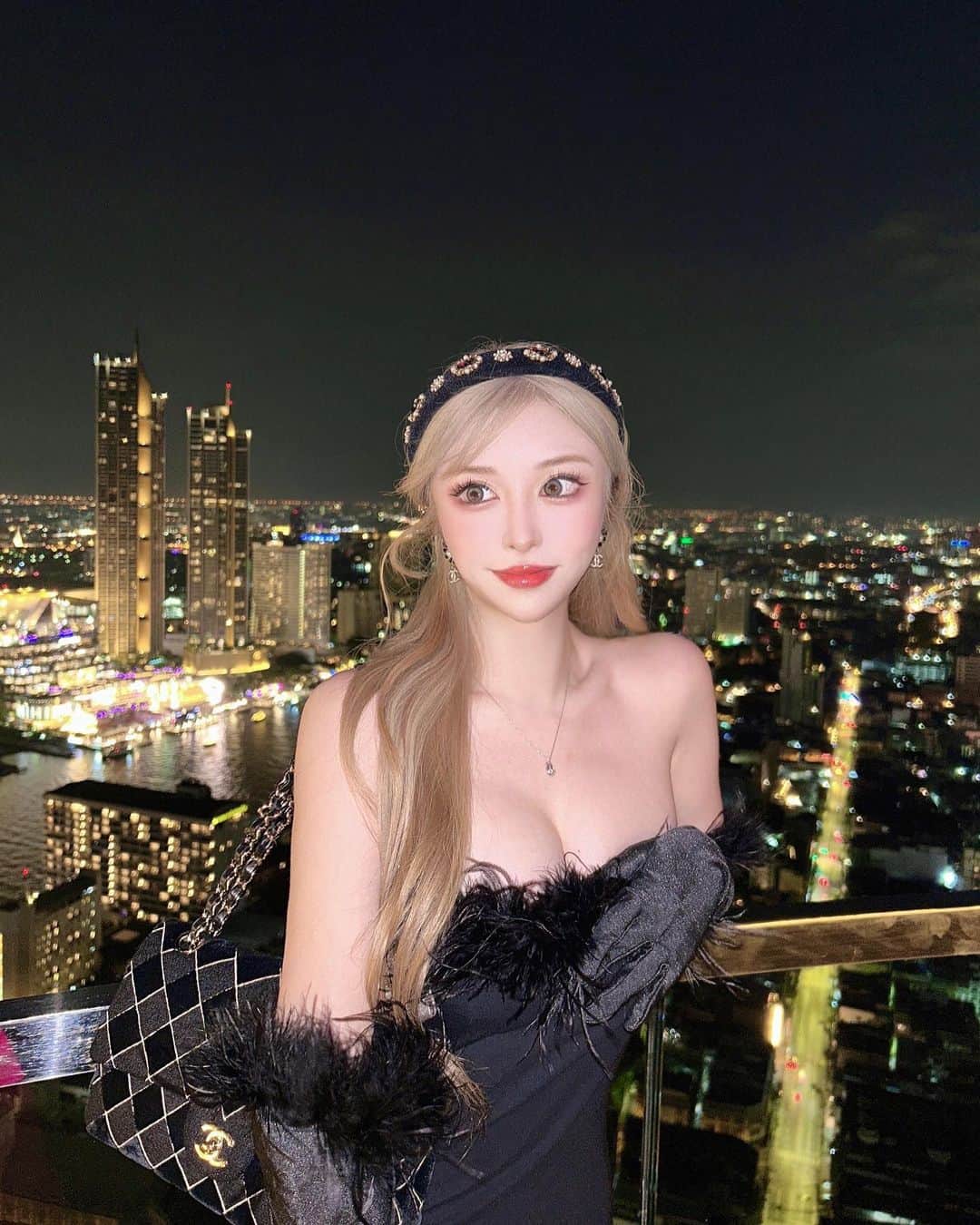 藤咲めいのインスタグラム：「party🫶🏻🖤 風強かった🥹 . . . #party #dress #makeup #fashion #snap #ワンホンメイク #ワンホンマツエク #金髪 #ハイトーンカラー #ブロンドヘアー #夜景 #タイ #🇹🇭 #thailand #bangkok #chanel」