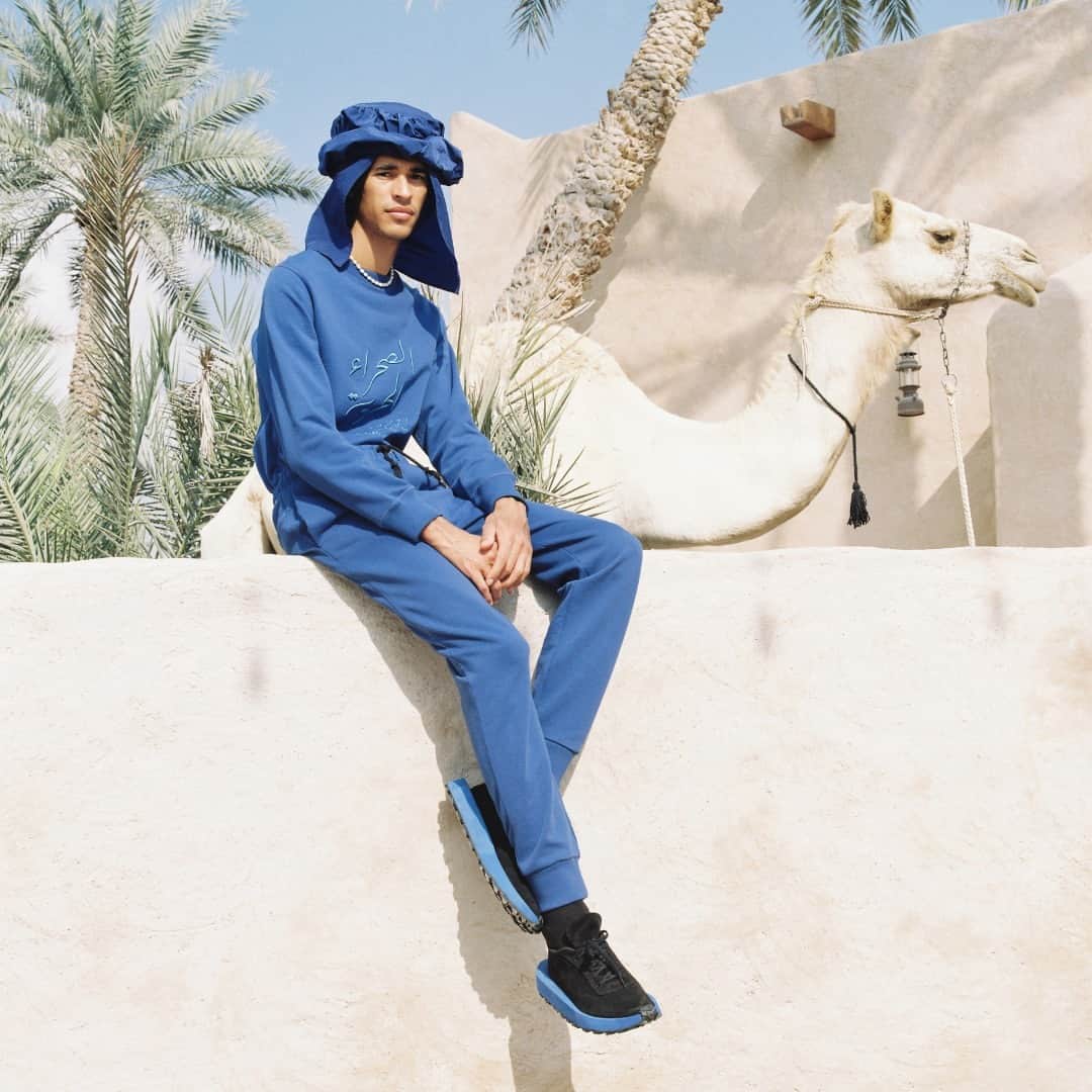 カシミ オムのインスタグラム：「For SS23, the Tuareg people, as well as the Saharawi and Sahel regions, act as the inspiration for the deep, unavoidable indigo hues that permeate this season.⁠ ⁠ Featured here, our HACHEM SWEATSHIRT and HARUN JOGGERS in TUAREG BLUE. Available online now.⁠ ⁠ Shot on location in Sharjah, UAE, by film photographer @tariqalhajri⁠ ⁠ #QASIMISS23⁠」
