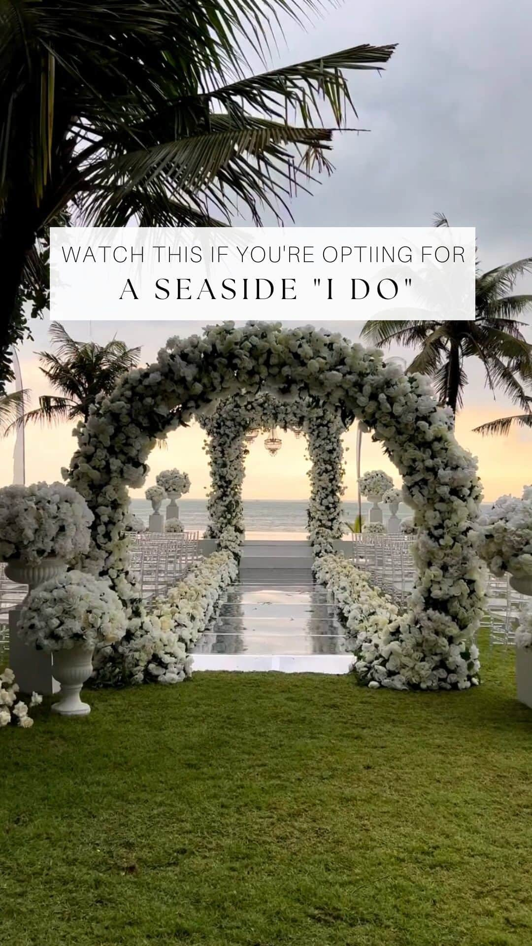 WEDDING APPARELのインスタグラム：「Highway to heaven ✨ Jaw-dropping floral installations, a mirrored aisle and the most picturesque backdrop come together for this modern-ethereal ceremony design! Can you see yourself saying “I Do” here? Tell us in the comments 👇   Floral & Decor @aisleproject @regina.saschia Planning : @luxuryweddingsindo @ria.kentjono Venue : Atas Ombak Villa by @elitehavens Rentals : @luxeliving.bali  #weddinginspo #glamwedding #seasidewedding #weddingplanning #weddingflowers #weddingarch #weddingaisle #weddingdetails #weddingdecor #weddingflowers #weddingday #weddingideas #weddingdecoration #weddinginspiration #weddingaisledecor #floraldesign #weddingcenterpiece #weddingflowers #weddingideas #floralarch #weddingceremony #weddings #eventstylist #eventdesign #luxuryflowers #weddingceremonydecor #weddinginspiration #weddingwednesday #bohoweddingdecor」