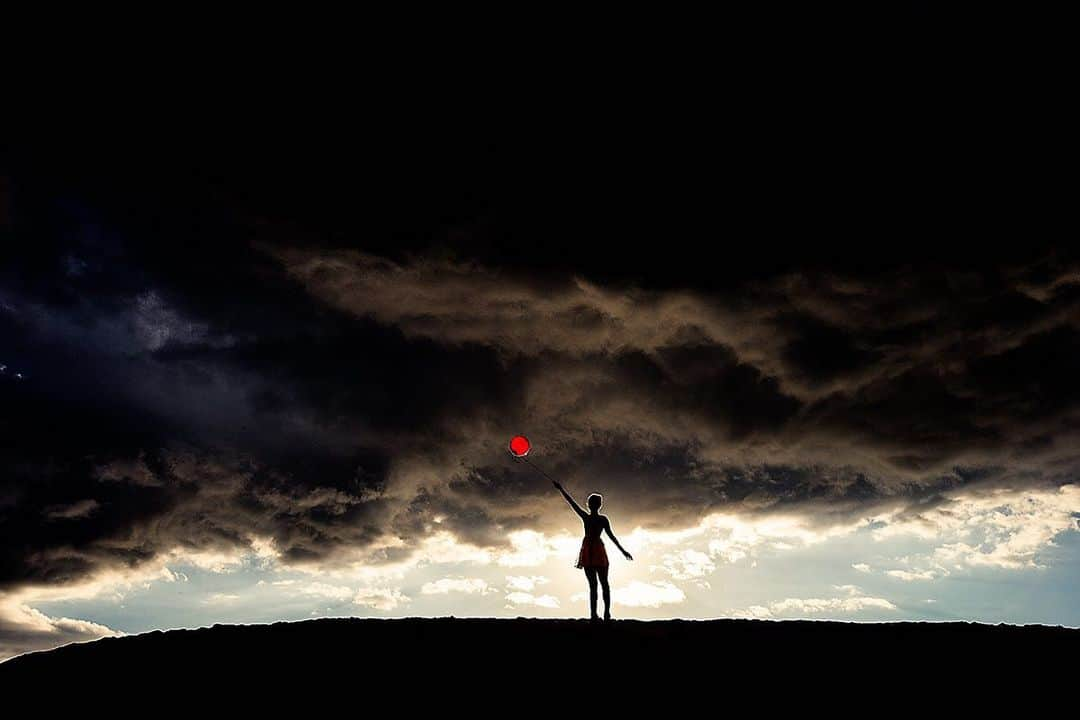 タイラー・シールズのインスタグラム：「Sometimes you have to be the joy in the chaos. When the storm comes you either take cover or you stand in it screaming at the top of your lungs here I am this image is from my Suspense series and just looks incredible someone just added a 72 inch of this to their collection and seeing it in that scale again was amazing. This is titled Red Balloon. Where would you hang this print?」