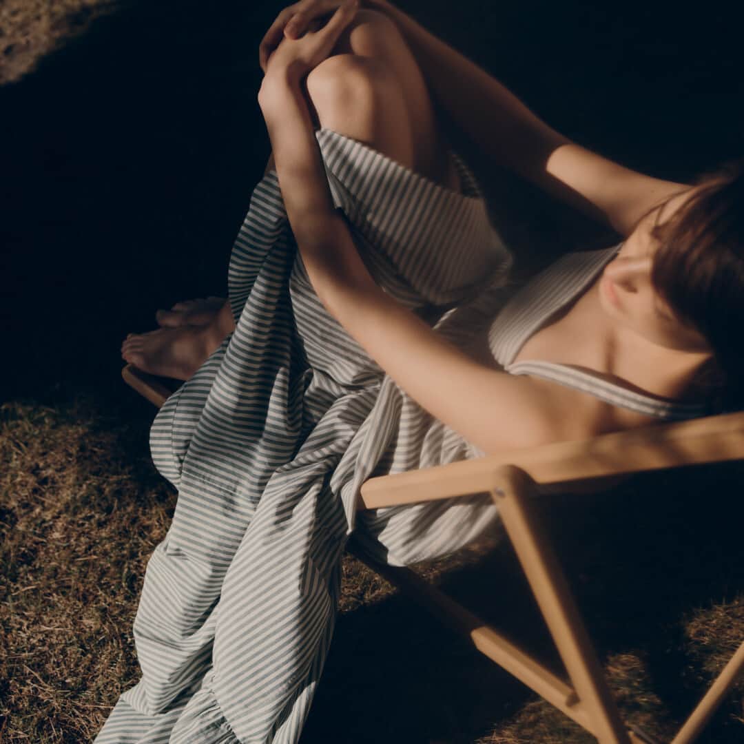 のインスタグラム：「Bonpoint Women SS23 | Between rays of sunshine. ​ In the creative idleness of summer, she gently slips on a striped poplin strap dress. ​  📷 @Charlotte_Lapalus​  #Bonpoint #BonpointFemme」