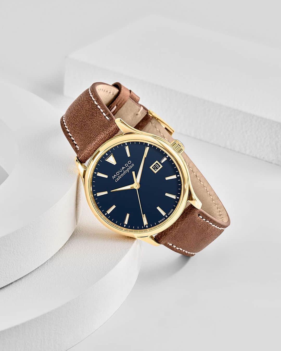 モバードのインスタグラム：「With a nod to our vintage designs, the #MovadoHeritage timepiece brings back the classics with a cognac top-stitched leather strap and classic gold plated buckle. Shop the collection on Movado.com.」