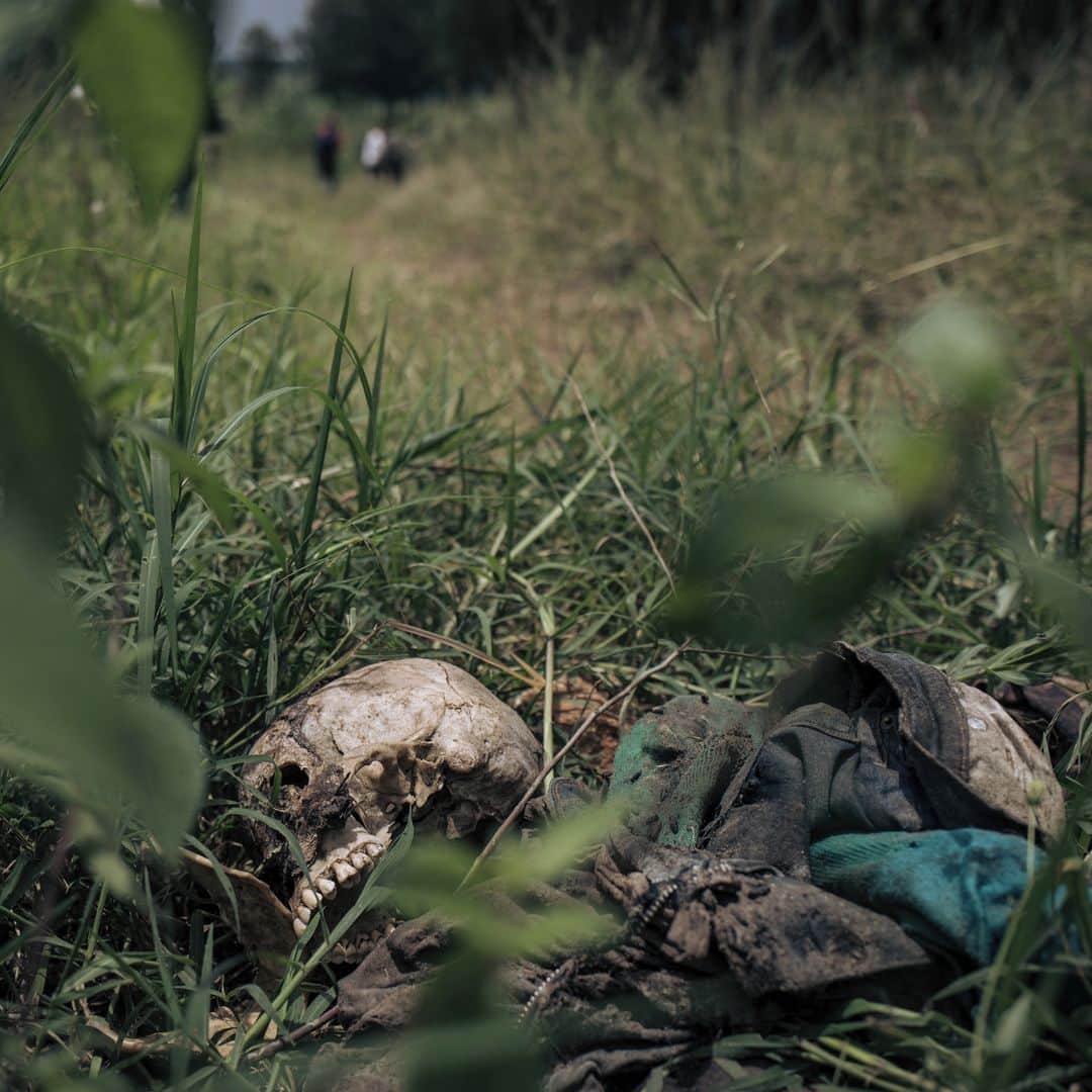 AFP通信さんのインスタグラム写真 - (AFP通信Instagram)「AFP Photo 📷 @huguet.alexis - Mass graves, unclaimed bodies haunt east DR Congo town -⁣ ⁣ In late November 2022, according to UN reports, M23 (March 23 Movement) fighters massacred at least 170 civilians in Kishishe in a retaliation attack after being ambushed by a local armed group. For a year, the fighters of the M23 - "Movement of March 23", a predominantly Tutsi armed group - have been advancing in Congolese territory, taking control of main roads, seizing towns and border posts.⁣ ⁣  The capture of Kishishe is also part of a fight by the M23 against the FDLR (Democratic Forces for the Liberation of Rwanda), a mainly Hutu armed group founded by former leaders of the genocide in Rwanda, exiled in the DRC. The latter have for years installed one of their bastions in the immediate vicinity of the village.⁣ ⁣ 1- A man carries a bucket and a World Food Program (WFP) bag in a street of Kishishe⁣ 2-A man poses for a photograph next to a hole in the ground used as a detention place by March 23 Movement (M23) fighters in Kishishe⁣ 3- An armoured plate taken from a bullet proof vest allegedly belonging to an March 23 Movement (M23) fighter⁣ 4- A man stands by a corpse lying on the side of a path in Kishishe⁣ 5- A corpse lies on the side of a path⁣ 6-Farmers return from the field in Kishishe⁣ 7- A boy walks around the remains of a school building used by March 23 Movement (M23) fighters as a military base in Kishishe⁣ 8&9- Boys move furniture from a school used by March 23 Movement (M23) fighters as a military base in Kishishe⁣ 10- A girl and a woman rest in front of their house」4月11日 20時01分 - afpphoto