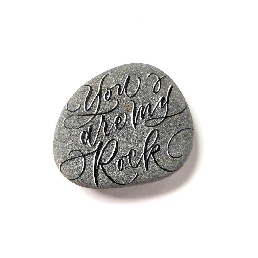 Sakura of America（サクラクレパス）さんのインスタグラム写真 - (Sakura of America（サクラクレパス）Instagram)「Hi! It’s Erica @ep_lettering here for another guest post! I love rock lettering, and Sakura products work so well on this surface.  Today I chose a nice smooth rock from the garden and lettered the phrase “You are my rock” using Sakura’s  0.5 mm mechanical pencil. Next, I used the Pigma FB brush pen to go over the letters. To add some highlights, I used the Gelly Roll White 10, which flows nicely on the surface and adds some contrast to the black brush lettering. Check out the video to see the process (sped-up).  The Pigma ink is waterproof, but the Gelly Roll is not, so I will probably add a craft sealant before this rock goes back out to the garden.」4月13日 0時03分 - sakuraofamerica