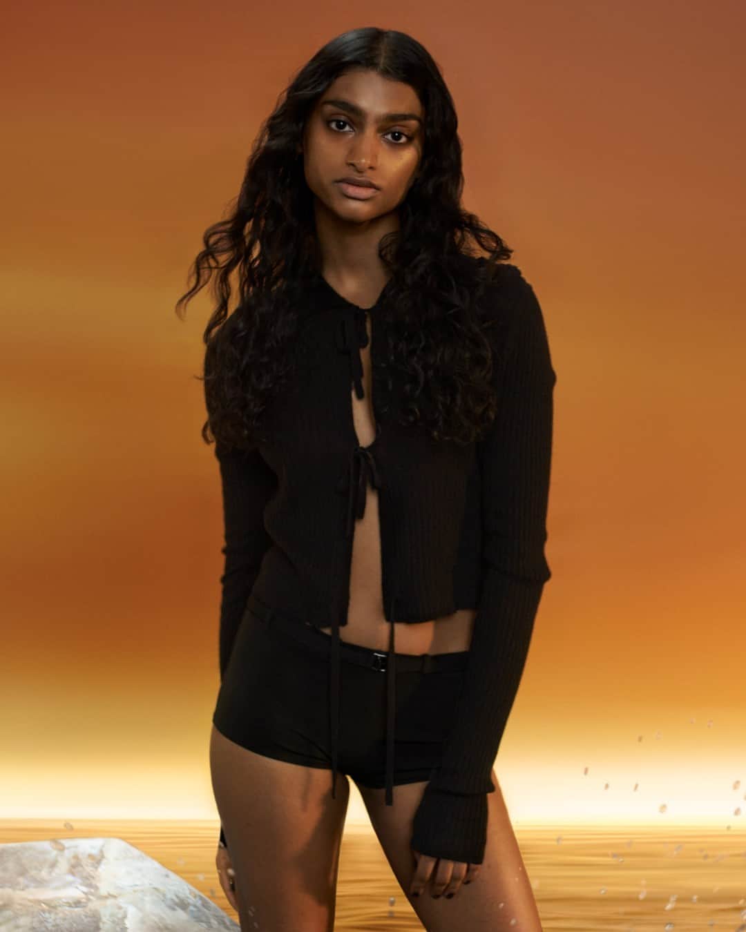 フィリッパコーのインスタグラム：「Priya Ravi wears the Filippa K Spring/Summer 2023 Cropped Tie Cardigan and Hipster Buckle Bottoms.  Photographed by @timothyschaumburg Model @priyaxravi Styled by @ondineazoulay Make up by @_georginagraham_ Hair by @odo_kiyoko Set design by @florinemilie」