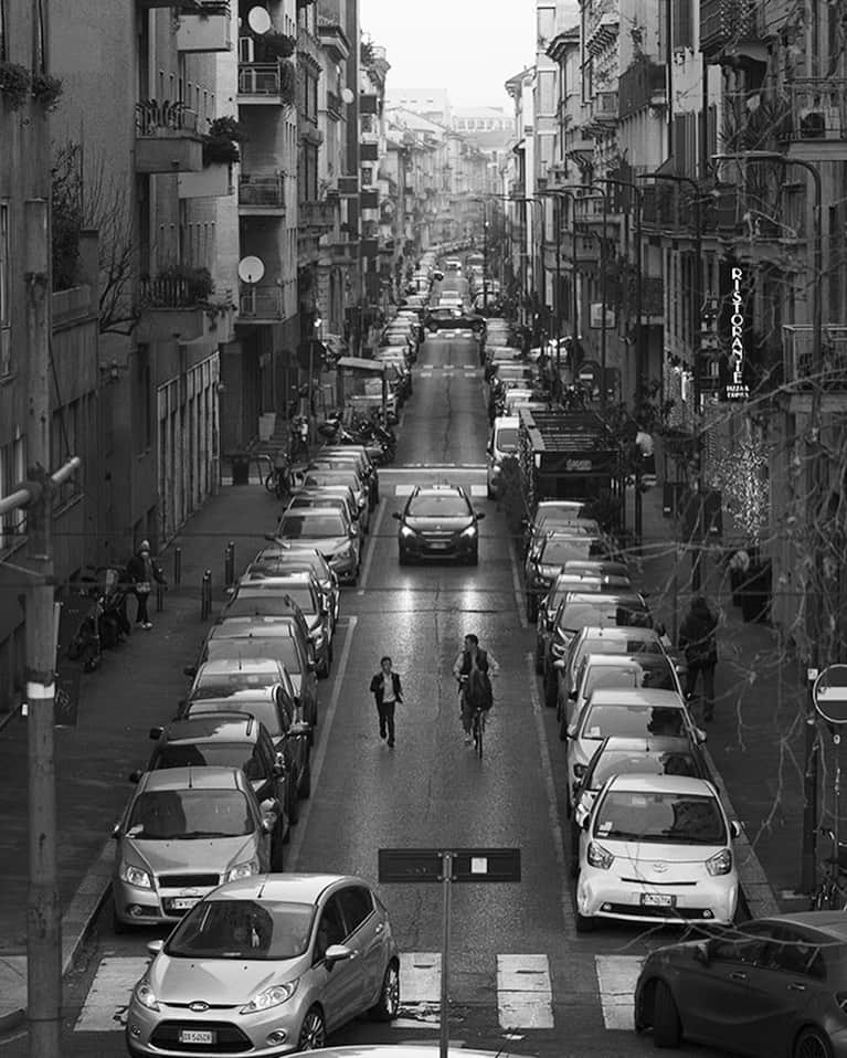 スコット・シューマンのインスタグラム：「After a particularly intense Italian class I was admiring this long view of a small Milano street when I saw this scene. A young kid running down the middle of the street with his father on a bike - I thought to myself “that’s unusual, you don’t see that everyday CRAP! I should take a photo!” I hurried and tried to capture the moment (which I think I did!) but it’s hard to say exactly what that moment is!  It’s just a simple moment that doesn’t mean anything but means everything! Milan (of course)」