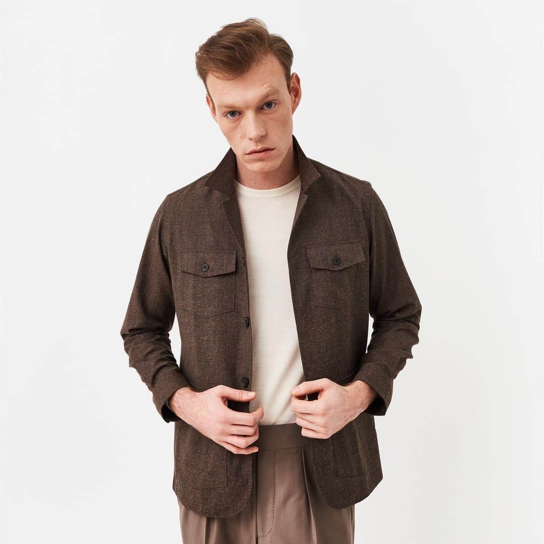 のインスタグラム：「As the seasons change, our Brown Fleck Overshirt works perfectly as a light layer for a casual, or formal, ensemble. Full of texture and character, it is worn here with our Cream T-shirt and Taupe Heritage Trouser—available now on 35 Savile Row and on edwardsexton.co.uk.  #edwardsexton #savilerow #menswear #london #tailoring #sartorial」