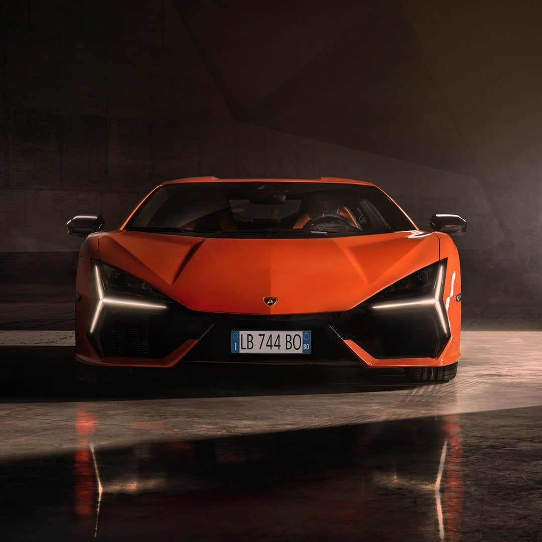 ランボルギーニのインスタグラム：「The wait is over. ​ Introducing our first super sports V12 hybrid plug-in HPEV: Lamborghini Revuelto. It’s here to make you feel a new energy and new kinds of emotions: the most electrifying ones.​  A 1015 CV V12 naturally aspirated engine combined with an eight-speed, double-clutch transverse gearbox and three electric motors.​ 13 drive modes, with all-wheel drive, also available in fully electric mode. Unique aerodynamics and design, which express the maximum synergy between efficiency, functionality and style.​ From 0 to 100 in only 2.5 seconds for a weight-to-power ratio of 1.75 kg/hp. ​ ​ New Lamborghini Revuelto.​ Get ready to be driven beyond. From Now On.​  #Lamborghini #Revuelto #FromNowOn  __ The vehicle is not yet offered for sale and is therefore not subject to Directive 1999/94/EC. The fuel consumption and emissions data is in the type approval stage」
