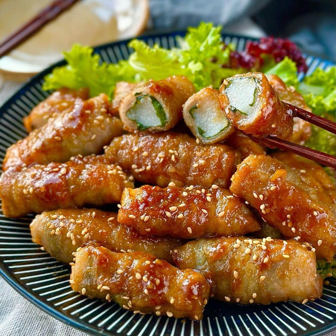 のインスタグラム：「今日は長芋と豚肉を使ったがっつりメイン系のやみつきレシピをご紹介します🤗✨ 長芋のシャキシャキ食感にお酢をきかせた甘辛ごまダレがめちゃウマです😋💕 さっぱり大葉のアクセントのおかげで飽きが来ず、がっつりいくらでも食べられますよ🙌🏻 普段のメインおかずにはもちろん、おつまみにもお弁当の一品にも大活躍の嬉しいレシピです😎🍻 それでは作り方をご紹介します✨       シャキッとやみつき♬ 長芋の甘辛ごまダレ肉巻き♬  【材料】３〜４人分 ◎長芋・・・２５０g ◎豚肉(スライス)・・・２００g ◎大葉・・・１０枚程度 (豚肉下味) ◎塩こしょう・・・少々 ◎片栗粉・・・適量 (甘辛ごまダレ) ◎しょうゆ・・・大さじ１.５ ◎砂糖・・・大さじ１ ◎みりん・・・大さじ１ ◎酢・・・大さじ１ ◎すりごま・・・大さじ１ ◎にんにく（チューブ）・・・３ｃｍ ◎しょうが（チューブ）・・・３ｃｍ     【作り方】 １．(甘辛ごまゴマ)を混ぜ合わせておきます。   ２．大葉を１／２に、長芋は皮をむいて１．５ｃｍ角の４ｃｍ幅に切ります。   ３．豚肉に塩こしょうで下味をつけ、大葉、長芋を乗せて巻いていきます。 ※今回は豚バラを使っていますがお好みで肩ロースやロースでもOKです。   ４．③に片栗粉をまぶし、少量の油をひいたフライパンに並べて中火で加熱します。   ５．２～３度ひっくり返しながら全体に焼き目をつけていきます。   ６．焼き目がついたら余分な油をキッチンペーパーでふき取り、（甘辛ごまダレ）を加えて全体に絡めながら煮詰めていきます。   ７．いい感じに煮詰まったら器に盛り付けて完成です。  シャキッと食感の長芋とジューシーな豚肉に、やみつきの甘辛ごまダレが絡んでめちゃウマです😋💕 さっぱり大葉のアクセントがたまりません🙌🏻 おかずにお弁当に大活躍する１品なので、ぜひお試しくださいね😌✨  　 より詳しいレシピはお手数ですがブログを見てください🤗✨ プロフィール欄のURL(@shinya6727 )、もしくはストーリーズのスワイプから飛べます😌✨  【お知らせ】 私の２冊目のレシピ本、「しにゃのやみつき！つまみ飯」発売中です🙌🏻 なるべくシンプルな食材や調味料、どこにでもある調理器具を使って作れるやみつきレシピをまとめた１冊になっております📚 お料理が好きな方も苦手な方も楽しんでいただける内容になっています😊  いつも通りの鶏むね肉やもやし、厚揚げといった、リーズナブルでヘルシーな食材を使った大満足レシピを多数掲載してます🙌🏻 とにかく幅広い方のお役に立てるレシピ本となっていますので、多くの方に手に取っていただけたら嬉しく思います😌🙏 お買い求めはAmazon、楽天などのネット通販か、全国の書店で📚 どうぞよろしくお願いします😊 ・ ・ ・ #レシピ #recipe #簡単レシピ #料理 #おうちごはん #時短レシピ #長芋 #potato #肉巻き #豚肉 #pork」