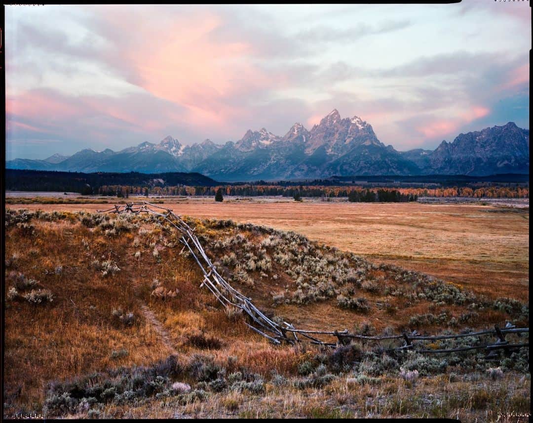 National Geographic Travelさんのインスタグラム写真 - (National Geographic TravelInstagram)「Photo by @taylorglenn | This view never gets old. I made the image over a decade ago with a large-format film camera (the border around the picture is the edge of the frame from the film scan). This well-known vista of the Teton Range is from the highway through Grand Teton National Park in Wyoming. A few who know this spot will recognize that the split-rail fence is no longer in this location; it has been replaced by something a bit more wildlife-friendly. I always loved that split rail and the layer it creates in this composition. It's a remnant of the Old West that is slowly fading away— kind of like film photography, I suppose. I sure love this image and this landscape. Follow @taylorglenn for more from Wyoming and beyond.」4月3日 1時00分 - natgeotravel
