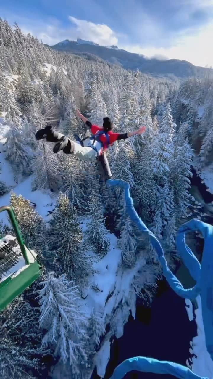 Explore Canadaのインスタグラム：「Wait for it….    🦢 Swan diving into the long weekend like 😎   📷: @whistlerbungee 📍: @whistlerbungee, @gowhistler, @hellobc   #WhistlerBungee #OnlyInWhistler #ExploreBC   [Video description: A person stands on top of the handrails of a bungee jumping platform, looking out over a snow covered river valley. They are tied to a large bungee cord. They jump, arms outstretched and swan dive into the river valley below.]」