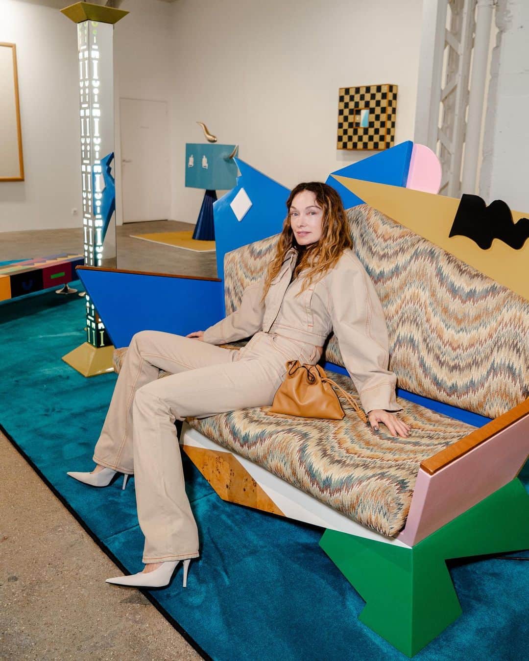 ケリーウェアスラーのインスタグラム：「POSTMODERN. Kreo Gallery is a must-see for me whenever I visit Paris. It was founded in 1999 by Clémence and Didier Krzentowski, who have established a distinctive presence in the gallery scene. During my recent visit, there was a special exhibition on Alessandro Mendini, one of my heroes of the postmodern movement. One particular highlight was the sofa I'm sitting in, of which only ten were ever made. Having only seen this piece in photographs, being able to see it up close and personal, along with several other works, was really special for me. XK」