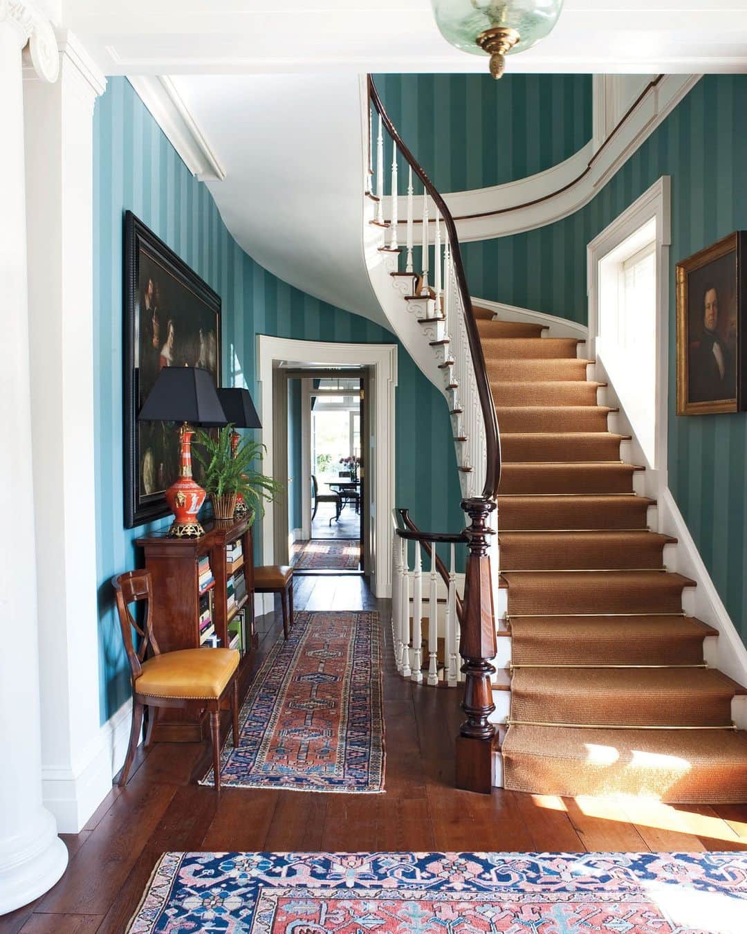 ELLE DECORさんのインスタグラム写真 - (ELLE DECORInstagram)「How do you begin decorating a 7,500-square-foot house? Designer Miles Redd (@milesredd) took cues from a Sultanabad rug he had found, which boasted rich hues of peacock-blue with greens and reds. “That was the springboard for us,” he explains. After trying several wall finishes, he opted for striped peacock-blue wallpaper in the entryway, punctuated by zippy tangerine lamps. The result is a palette that establishes the elegant yet whimsical spirit that defines the rest of this fabulous house.  Click the link in bio to tour this stately Greek Revival, as seen in the ELLE DECOR archive. Written by Cynthia Kling. Photographed by @williamwaldronphoto. Styled by @casamotachic.」5月5日 7時10分 - elledecor
