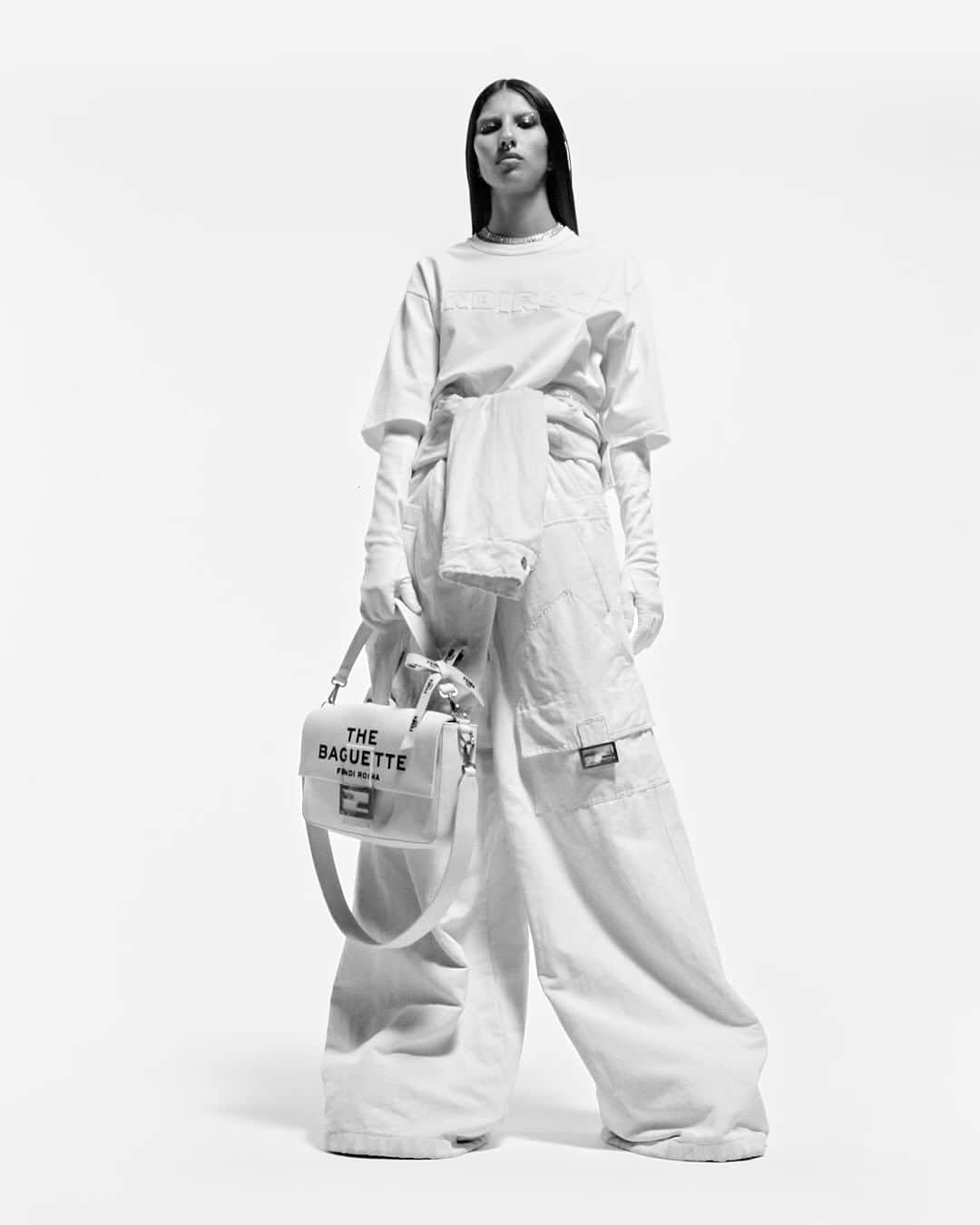Fendiのインスタグラム：「The icon, out loud. The #FendiBaguette collides with Marc Jacobs’ signature logomania in #MarcJacobsXFendi.  Get exclusive early access to the collection and limited-edition styles—subscribe to the Fendi newsletter at the link in bio.  Artistic Director of Couture and Womenswear: @mrkimjones​ Artistic Director of Accessories and Menswear: @silviaventurinifendi ​ Artistic Director of Jewelry: @delfinadelettrez​ Artistic Director: @themarcjacobs  Direction: @mario_sorrenti  Styling: @alastairmckimm Hair: @bobrecine Makeup: @aarondemey1  Casting: @samuel_ellis   Model: @b1tchiest」