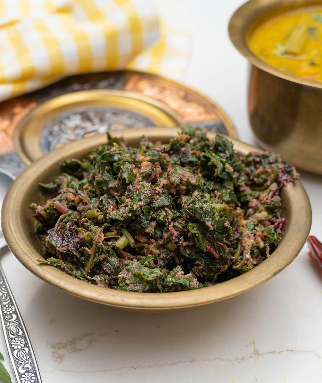 Archana's Kitchenのインスタグラム：「You must try this Keerai Thoran, it's an absolutely refreshing and tasting recipe that is made from amaranthus leaves, tossed along with ground coconut and cumin. Serve it along with sambar and hot steamed rice topped with ghee!  Ingredients 2 cups Red Amaranth Leaves, washed and chopped 1 teaspoon Coconut Oil 1/2 teaspoon Mustard seeds 1 teaspoon White Urad Dal  2 sprig Curry leaves To Grind 1/2 cup Fresh coconut 1 tablespoon Cumin seeds  1 tablespoon Whole Black Pepper Corns Salt, to taste  👉To begin making the Keerai Thoran Recipe, wash and chop the leaves and prep all the remaining ingredients 👉Into a pressure cooker, add the chopped amaranthus leaves (keerai) along with a little salt and a tablespoon of water. Pressure cook the keerai for one whistle and turn off the heat. 👉Release the pressure immediately to retain the fresh green colours of the greens. You can do this by lifting the weight with a fork or by placing the pressure cooker under running water. Keep this aside. 👉Into a small jar of the mixer grinder add the coconut, cumin seeds and black pepper corns. Blend to make a coarse mixture without adding any water. 👉Preheat oil in pan on medium heat; add the mustard seeds and urad dal and allow it to crackle and the seeds to turn golden brown. Stir in the curry leaves, the ground coconut mixture and the cooked keerai. 👉Saute for a couple of minutes to combined all the Keerai and coconut mixture. Check the salt and add more the adjust the taste if required.  👉Turn off the heat and transfer the Keerai Thoran to a serving bowl and serve warm. 👉Serve the Keerai Thoran Recipe along with some Steamed Rice and Kerala Style Ulli Theeyal Recipe (Small Onions Roasted in Spicy Tamarind Recipe) for your lunch.」