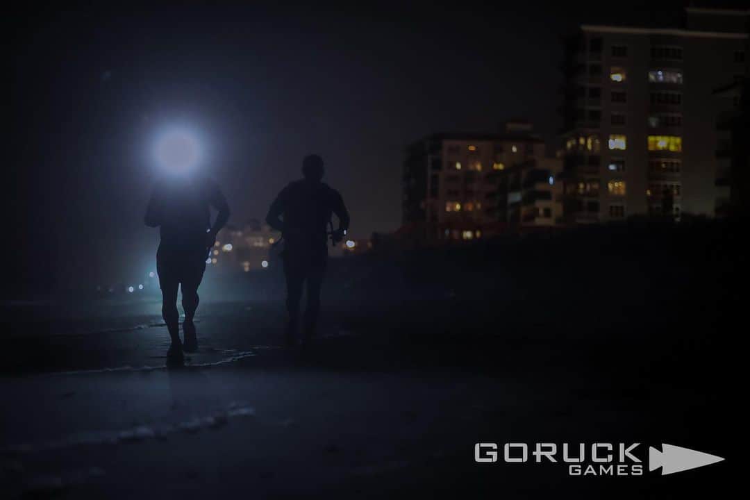 カーリー・ウォパットさんのインスタグラム写真 - (カーリー・ウォパットInstagram)「GORUCK GAMES // EVOLUTION 002: HIGH WALKER  “I bet you’re thinking, what is a place like me doing in a girl like this?”  I overheard this quote while my roommate was watching “The Mummy”, and it stuck with me because I thought it was funny. Throughout this evolution, it kept replaying in my head. As we ran through ocean water & fog with 30# rucks on our backs, saturated socks & shoes squishing with every step, and a 50# flag pole held like a torch at the front of our mad assembly charging through the night.. the hilarity of our current reality made me want to both burst out laughing and crying at the same time. This, however, is what I’m here for.   Evolution 2 turned out to be a 16 mile ruck on the beach, starting at sunset, and continuing through the dark. We began by getting wet & sandy, assuring that discomfort was prevalent. The instructions were simple: run. And don’t stop until you’re told to. Which led us all to face the question: can I keep going when there’s no end in sight? Better yet, how do you pace a race of unknown distance? Run fast, but not too fast. Don’t be first, but don’t be last.   It was a spiritual thing. Eventually, all things come to an end. But you must keep going. The philosophical parallels to life were overwhelming, and they take time to reflect on and fully sink your teeth into. But I bit down hard on this one, and kept putting one foot in front of the other.  At first I just told myself to keep up. And I did. I stayed with the group for the first 4 miles. A cadre member told us to turn around, so I prayed that our starting point would be our finish line, totaling 8 miles. But we kept running. Another 4 miles in the opposite direction, then back. 16 miles total.   I started to fall behind after mile 4. I could see green glow sticks on rucks elusively in the distance. I was alone most of the time, and feeling left behind evoked a sense of desperation.   I found spurts of energy. The ocean water splashing over my shoes seeped some life back into me. Doubts crept in. Pain. My feet hurt like hell. I ran out of water. I’d pass a few other lone soldiers from time to time. Hey brother. Hey sister. Keep going.   And we did.」5月7日 3時43分 - carlywopat