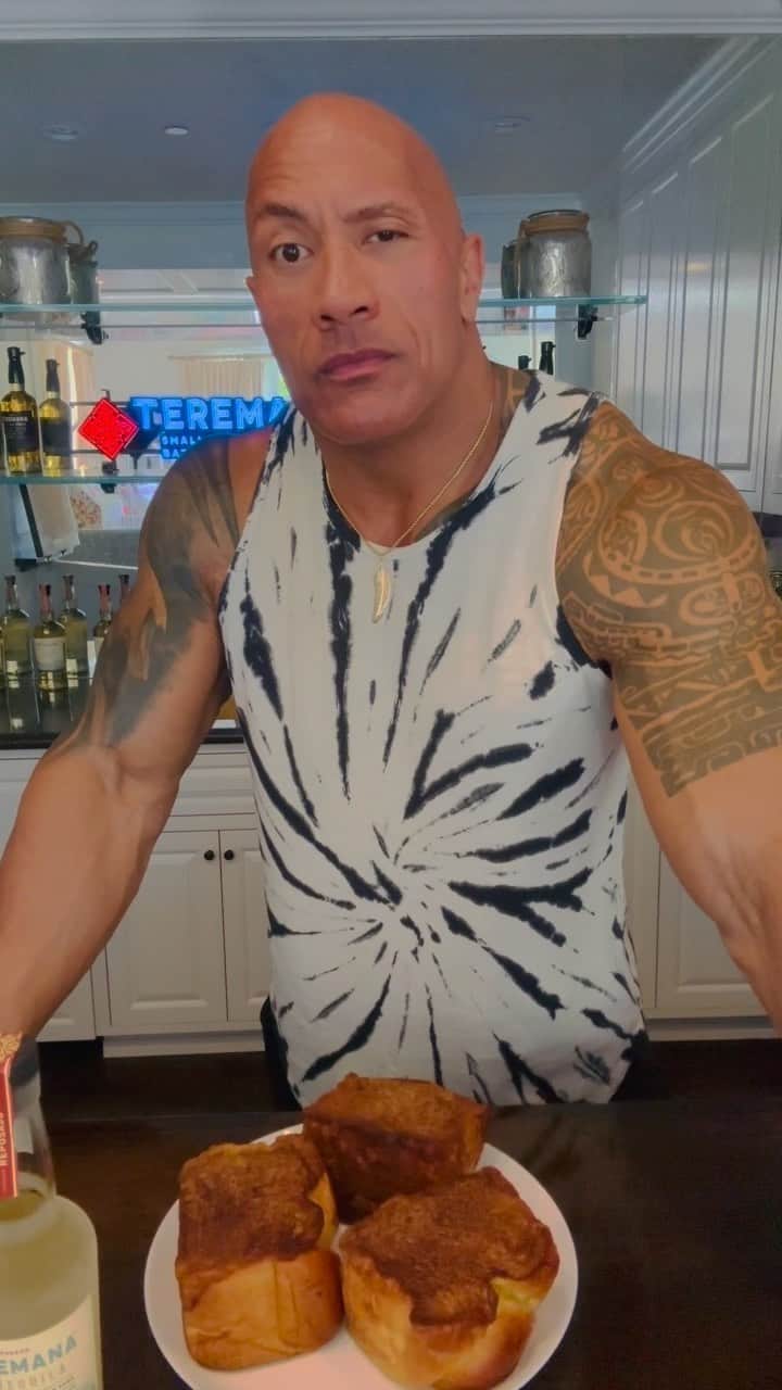 ドウェイン・ジョンソンのインスタグラム：「It’s baaaaack 🤯 🍞 😈 🥃 the world famous (infamous) #DJToast aka @brique_la!   An insanely delicious #cheatmealsunday today as I broke out the @teremana, rocked some Prince and devoured my signature French Toast ‼️🍞  ✅ 4” thick slices (secret recipe)   ✅ vanilla bean whipped cream   ✅ peanut butter coconut maple syrup   ✅ toasted coconut chips soaked in Teremana   I love creating legendary cheat meal experiences and this stuff brings my ravenous ass SO MUCH JOY  🤣🙋🏽‍♂️  Big shout to my personal chef👩🏽‍🍳 @rockymercedes for her passion, talent, innovation, and willingness to cook and bake anything my crazy mind comes up with 😊🥃   Go enjoy some @brique_la #DJToast on @goldbelly and devour your well earned cheat meals, my friends😈  #WorldFamousDJToast  @brique_la」