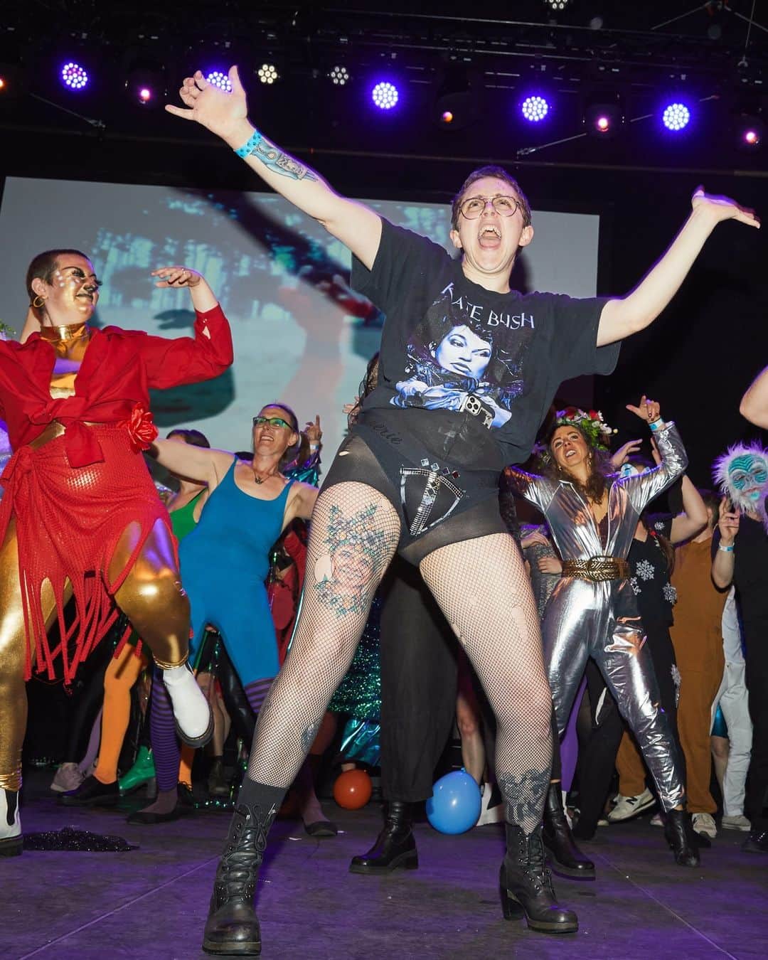 New York Times Fashionのインスタグラム：「The “Night of 1,000 Kates,” an annual variety show in Philadelphia, taps into the British art-pop singer Kate Bush’s lasting appeal.  The variety show started as a party for “our friends and community of queers and weirdos” to celebrate their appreciation for Bush, said Danielle Redden, a founder of “Night of 1,000 Kates.”  The annual event started nine years ago, but this year’s edition, held on April 1, delivered on the event’s numerical promise for the first time: About 1,100 people attended, according to the show’s organizers. Many of the celebrants wore crimson dresses, dark sequins and other fancy goth attire inspired by Bush, who, as in years past, was present only in spirit.  About 80 performers, including professional and amateur musicians, dancers and video artists, participated in more than 20 acts inspired by the singer. The crowd at Union Transfer, a concert hall just outside Philadelphia’s Chinatown, was almost twice as big as that of last year’s show.  The rising interest in “Night of 1,000 Kates” reflects the lasting appeal of Bush, whose 1985 song “Running Up That Hill (a Deal With God)” topped charts in 2022 — 37 years after it was released — thanks largely to its prominent use in “Stranger Things” on Netflix.  Step inside the “Night of 1,000 Kates” at the link in our bio. Photos by @aaronrichterstudio」