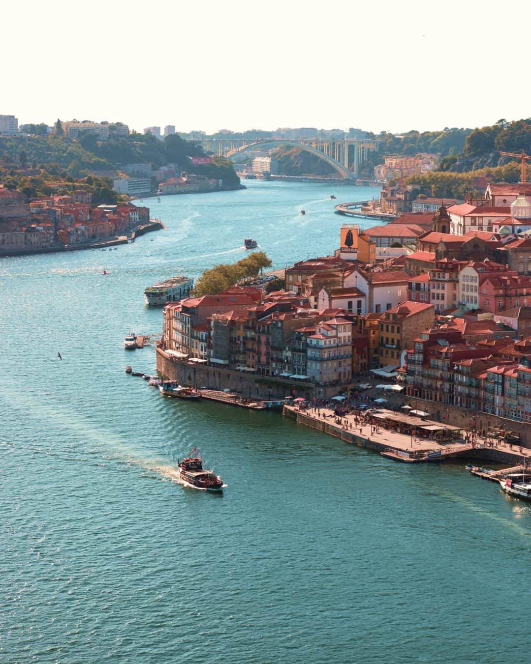 Rosetta Stoneのインスタグラム：「#Porto is the second largest city in #Portugal with a ton of history and full of culture.  Here are 10 interesting things you might not know about Porto:  1. Porto was originally called Portus Cale, which influenced the name of the country Portugal. Historians argue the name comes from either: - The Gallaeci, a Celtic tribe of Iberia - A Celtic word meaning “port” (the place where boats dock) - The Greek word "Καλλις" meaning “beautiful” (referring to the beauty of the Douro valley) - The Latin word "calidus" meaning "warm" ("Portus Cale" thus meaning "warm port")  2. While Porto developed in the 4th century ACE, the earliest evidence of settlers dates back to the 8th century BCE. This makes Porto one of the oldest European cities.  3. Porto is fondly called “Invicta”, which means "invincible" in Portuguese. This nickname comes from the 19th century Portuguese civil war when the enemy failed to conquer the city.  4. In 1415, Porto residents donated all of their meat reserves to soldiers for the conquest of Ceuta, which left them with only animal tripe to eat. After that, the people of Porto were called "Tripeiros" (tripe-eaters). The nickname stuck and is still used today.   5. Porto is known as the city of bridges due to its 6 iconic bridges that span the Douro River.   6. The Sao Bento train station in Porto is considered one of the most beautiful train stations in the world.  7. Port wine comes from this region. This fortified wine is widely accepted as the city’s dessert wine, especially as it is made along the Douro River.  8. A Francesinha is the city’s typical dish. This sandwich is made with different kinds of meat and sausage, cheese, and a delicious tomato beer sauce.  9. One of the largest street festivals in the world takes place in Porto on June 23 to celebrate the patron saint of the city – Saint John. Quirky traditions during Festa de São João do Porto include smashing each other's head with plastic hammers, jumping over bonfires (to prove your courage), and offering friends basil plants decorated with handwritten poems.  10. The historic center of Porto was declared a World Heritage Site by UNESCO in 1996.  Will you add Porto to your #bucketlist?」