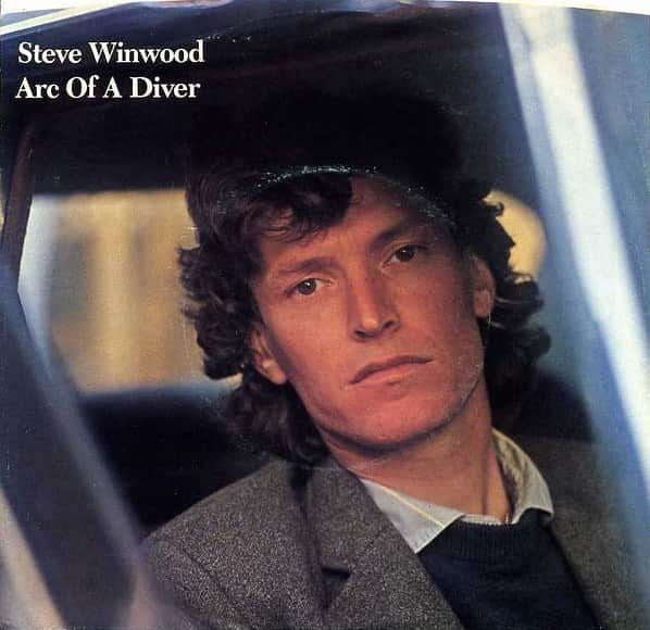 スティーヴ・ウィンウッドのインスタグラム：「#OnThisDay in 1981, the Album ‘Arc Of A Diver’ rose to #3 on the Billboard Top-200, earning Steve his first top-ten hit as a solo artist with “While You See A Chance".  But just before finishing the lead single, he inadvertently erased the drums from the beginning of the tape. The mistake turned out to be a revelation that made the song work:  “What happened there was that in the studio, I had record switches for each track that were mounted flush with the board desk, on top of which was habitually piled reams of notes and paperwork. At one point, I inadvertently knocked a record button on as I went down into the studio to do a vocal. Twenty bars into the song, I suddenly said to Nobby Clarke, my engineering assistant, ‘I can't hear the bloody drums!’   He stopped the tape immediately, and we found that we'd accidentally wiped the drums off the first part of the track - originally they'd come in at the top of the tune. I spent months trying to patch in the drums again, and never got it right. We were getting close to delivery day for the tapes to be mastered, so I just left the drums and vocal out, and reshifted all the verses. It actually made the song. That's how bizarre the recording process is.”」