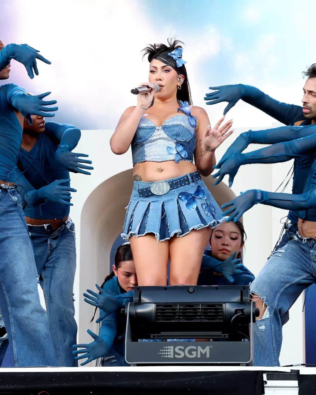 Fashion Weekのインスタグラム：「Denim darling. #KaliUchis wears custom #DolceGabanna during her #Coachella set. The look is complete with a denim bustier corset, a skirt embellished with Swarovski crystals, and silk butterflies.  Photos courtesy of @gregnoire and @gettyimages」