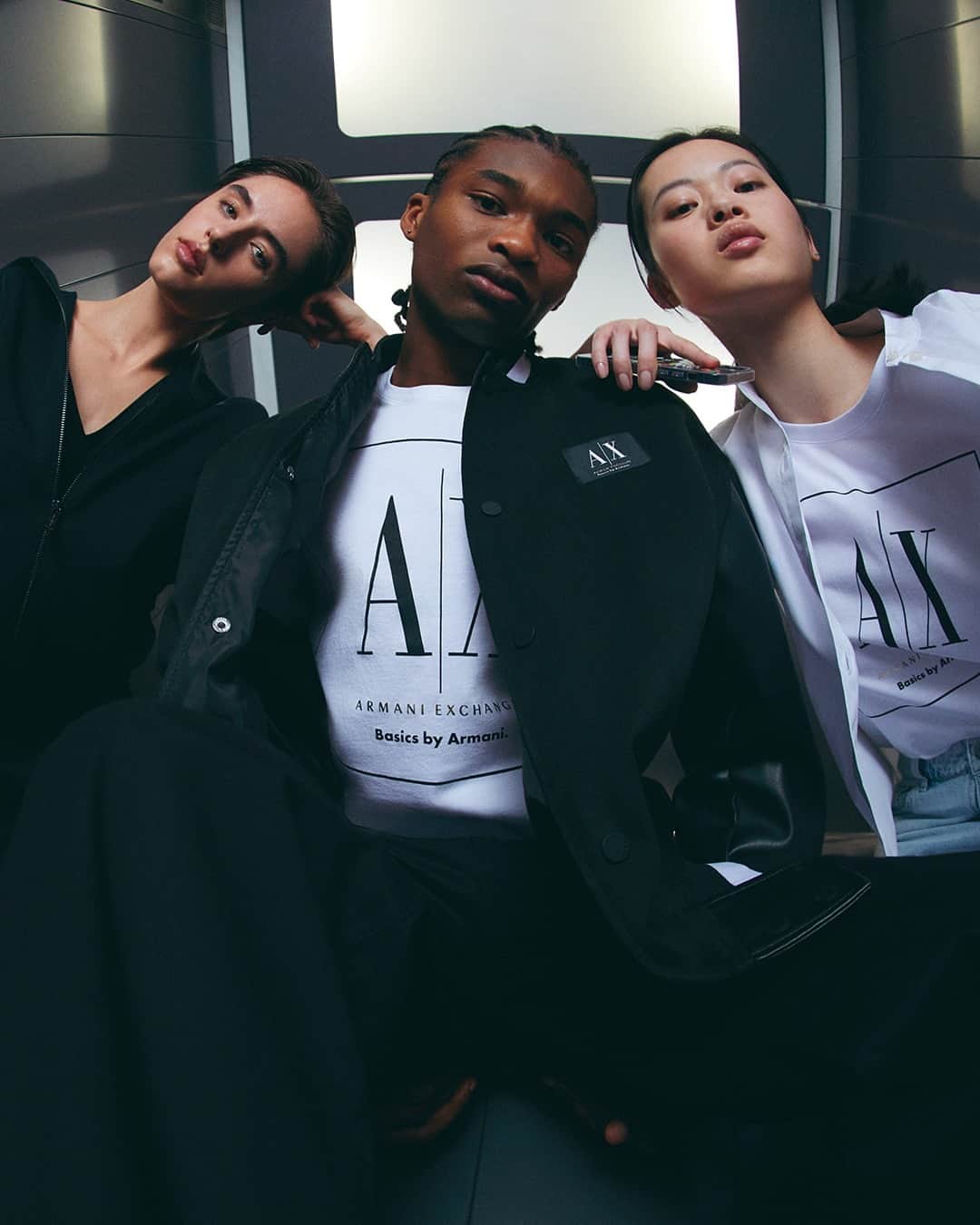 ジョルジオアルマーニのインスタグラム：「Vibing in #AXss23 ⁣ ⁣ Discover the iconic logo t-shirts and more from Basics by Armani⁣ ⁣ Photo @mescondi⁣ Models @osmanjalloh_ @opheliehim @syd_walker」