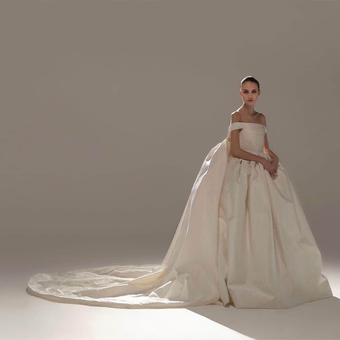 ステファンローランのインスタグラム：「EPURE Book an appointment in our Haute Couture showroom in Paris and push the doors to an intimate and unique universe. Tie the knot in a gown inspired by the French savoir faire.   LA BELLE HISTOIRE  Infante gown in white satin duchess embroidered with crystals. Built in corset and a long cape you can remove as the celebrations evolves.   #StephaneRolland #Bridal #Wedding」
