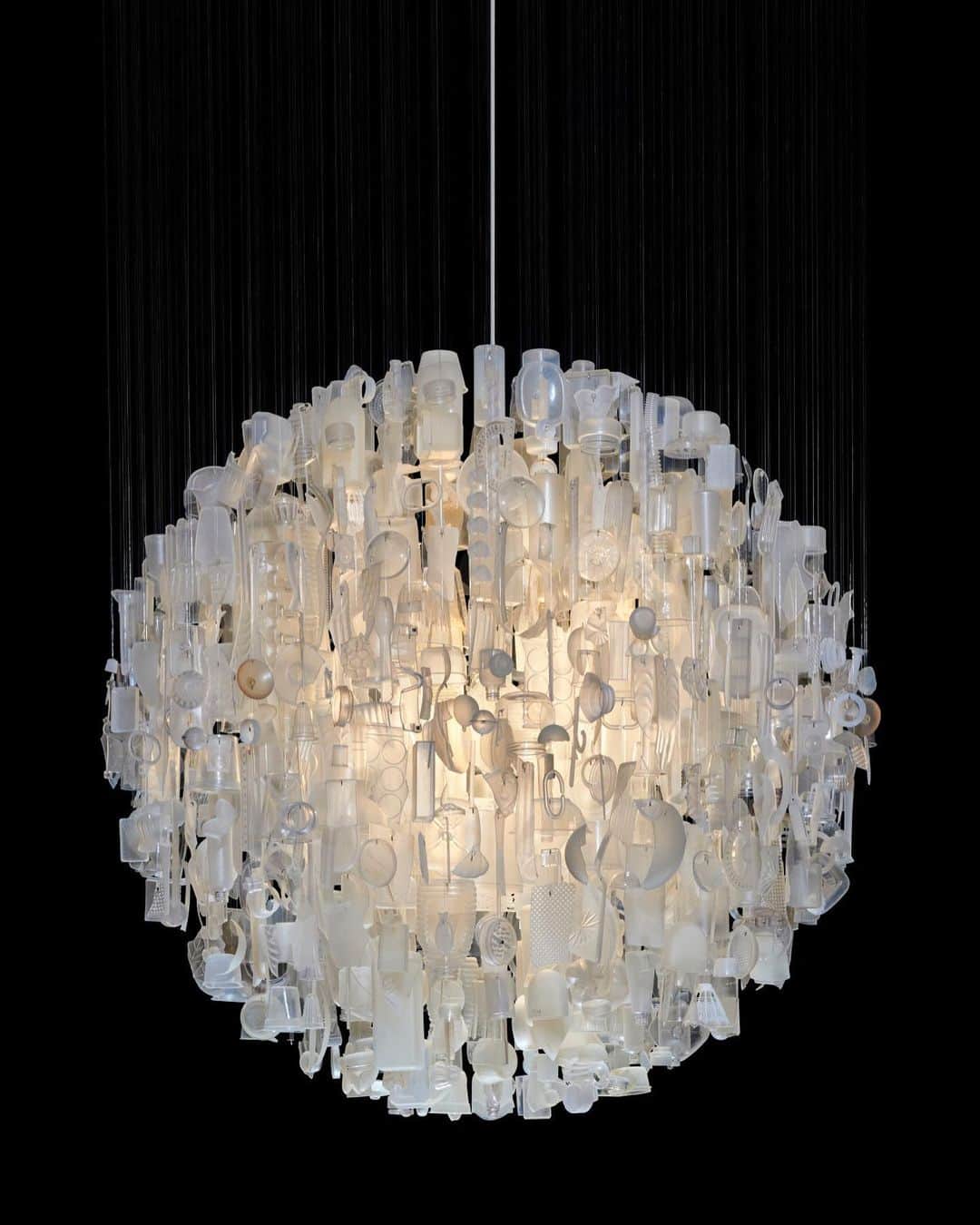 クリスティーズのインスタグラム：「On this #EarthDay, we look at the work of British artist and designer Stuart Haygarth. 🌎⠀ ⠀ For the past two decades Haygarth has created beautiful installations, often in the form of chandeliers, from marine detritus collected across Britain's beaches.⠀ ⠀ In Haygarth's 'Tide Chandeliers', the plastic objects are transformed into sandblasted glass elements produced by the abrasive nature of the sea water and sand.⠀ ⠀ 'The work's spherical shape is a reference to the Moon, which affects the tides washing up debris onto the coastline' - Stuart Haygarth.⠀ ⠀ 🔗 Follow the link in bio to read our interview with the artist.  ⠀ #artforahealthyplanet #artforglobalgoals @ART2030org @UnitedNations #stuarthaygarth」