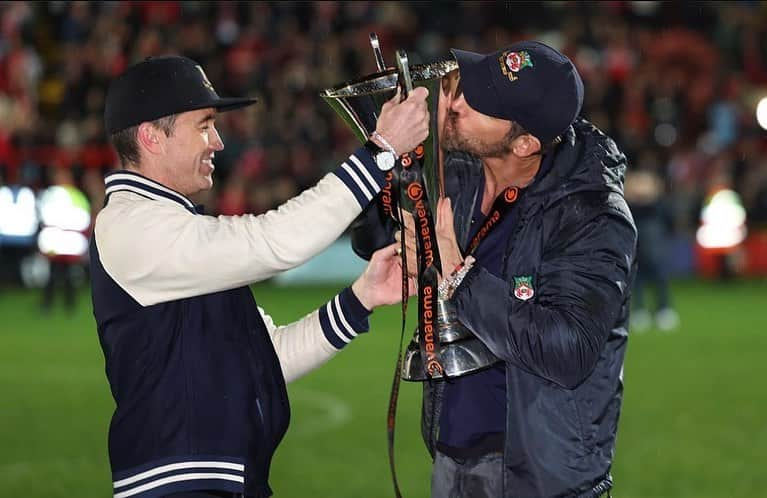 ライアン・レイノルズのインスタグラム：「Everything I own smells like champagne, beer and grass. I’m still somewhere between giggling and sobbing. This town and this sport is one of the most romantic things on earth. Thank you, @wrexham_afc ⚔️🏴󠁧󠁢󠁷󠁬󠁳󠁿⚔️」