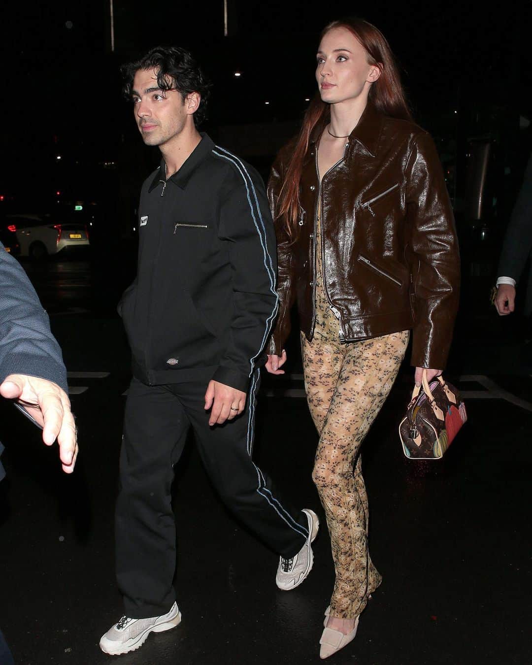 ELLE UKさんのインスタグラム写真 - (ELLE UKInstagram)「#SophieTurner supported her husband Joe Jonas as he performed a concert at London's Royal Albert Hall earlier this week. For the occasion, she rocked a Seventies-inspired look which comprised of a sheer floral jumpsuit, nude pumps and a brown men’s biker jacket from Our Legacy.  The actor accessorised the ensemble with a micro Louis Vuitton x Yayoi Kusama Speedy bag.」4月23日 17時21分 - elleuk