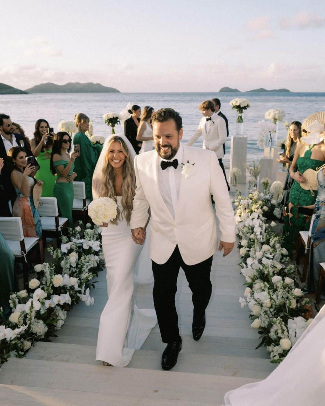 Ceci Johnsonのインスタグラム：「Forever looks good on these two. 🤍  Swipe for more details of their lush island wedding in St.Barths, as seen in @TheKnot. ✨  Invitation Design & Event Branding: @cecinewyork Planner: @epicpresentations Event Designer: @epicpresentations 📸 & 🎥: @thebrothersmartens Ceremony & Reception Site: @nikkibeachsaintbarth Florist: @b_floralevents Officiants: Tori Bradburry & Josh Sepkowitz Wedding Dress: @alexperryofficial Reception & After-Party Dresses: @berta via @bblewisville Veil: @bblewisville Suits: @balanicustom Engagement & Wedding Rings: @diamondsdirect Hair and Makeup: @matwulff Wedding Party Attire: @alexperryofficial, @balanicustom Rental Equipment: @nikkibeachsaintbarth Catering: @nikkibeachsaintbarth Cake: @chokolavany.stbarth Entertainment: @nikkibeachsaintbarth, @blackrabbitprojects Welcome Bags: @epicpresentations Transportation: @coolrental  #couturedesign #luxurydesign #luxurystationerydesign #luxuryweddingstationery #luxurysignagedesign #eventbranding #cecicouture #weddingprograms #ceciwedding #placecards #stbarth」