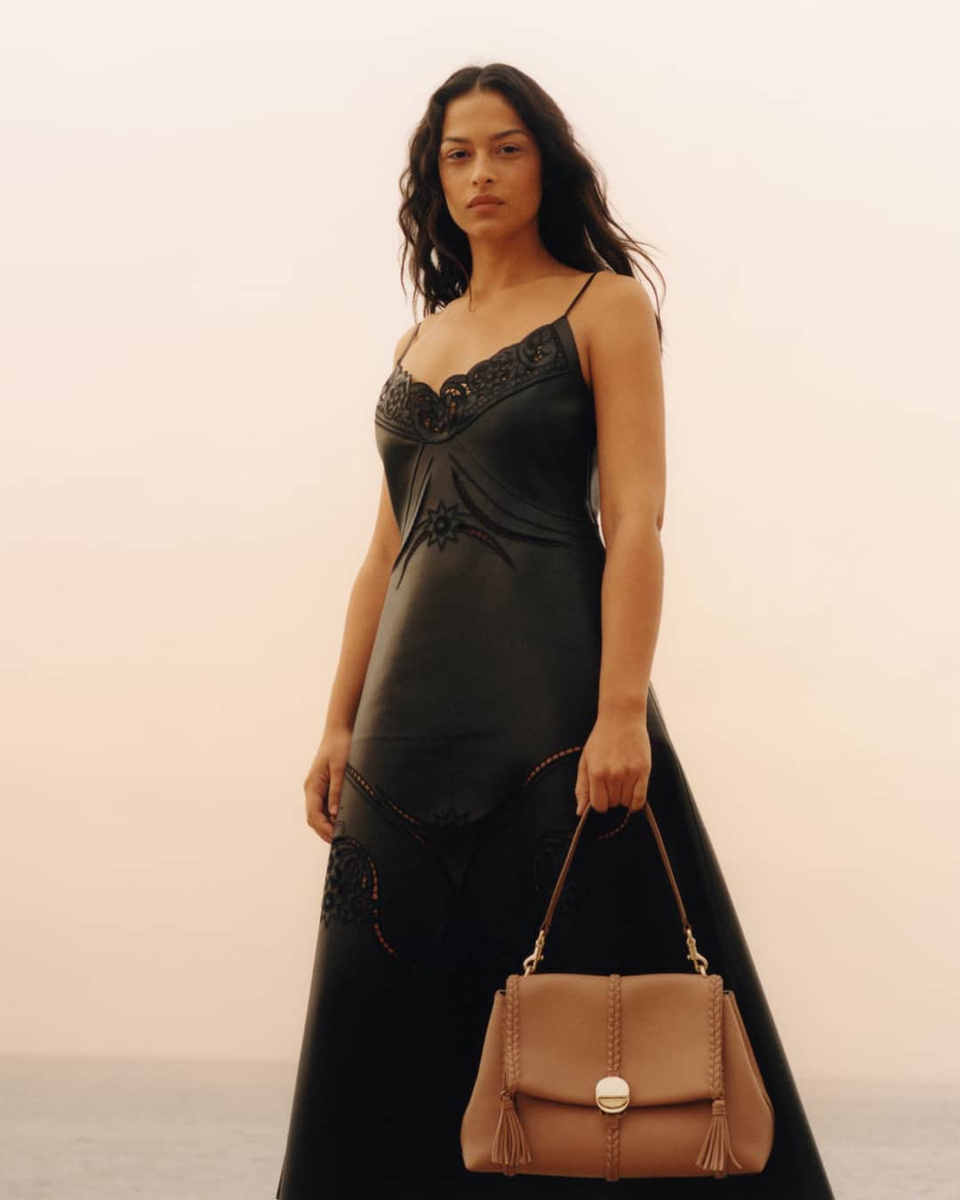 のインスタグラム：「@devynfaithgarcia carries the Penelope shoulder bag in caramel leather, complete with leather braiding and signature metal coin closure inspired by the Maison's jewellery archive.   Photographer: @colin_dodgson  #ChloeSS23」