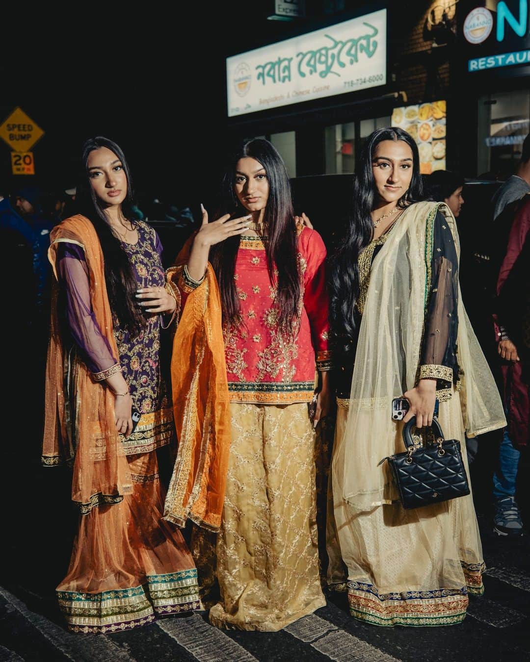New York Times Fashionのインスタグラム：「South Asian Muslims, both local to New York City and from other boroughs and states, flocked to Jackson Heights on Thursday evening to celebrate Chand Raat, a festival on the night before Eid al-Fitr to herald in the holiday.  The celebration encapsulates the intersection of religion and culture, translating to “night of the moon” in Urdu and Hindi. It’s observed on the last night of Ramadan, when the new moon is sighted, indicating the end of the month of fasting.  The night’s action was centered in Diversity Plaza, the town square that honors the global mash-up of Jackson Heights. With some 180,000 people and 167 languages, it may be the most diverse neighborhood in the world. And it’s home to a prominent South Asian community. “Eid Mubarak!” signs swung over the streets. Punjabi, Bollywood and Bangla anthems blasted from car speakers. Vendors set up tables selling salwar kameez of all colors and elaborate gold jewelry.  “That’s why I come. Because you feel seen,” said Anik Khan, a musical artist and an influential member of the community who has been celebrating in Jackson Heights since he was a kid.  Tap the link in our bio to read more from @sadibahasan about the Chand Raat celebration in Jackson Heights. Photos by @amirbangs」