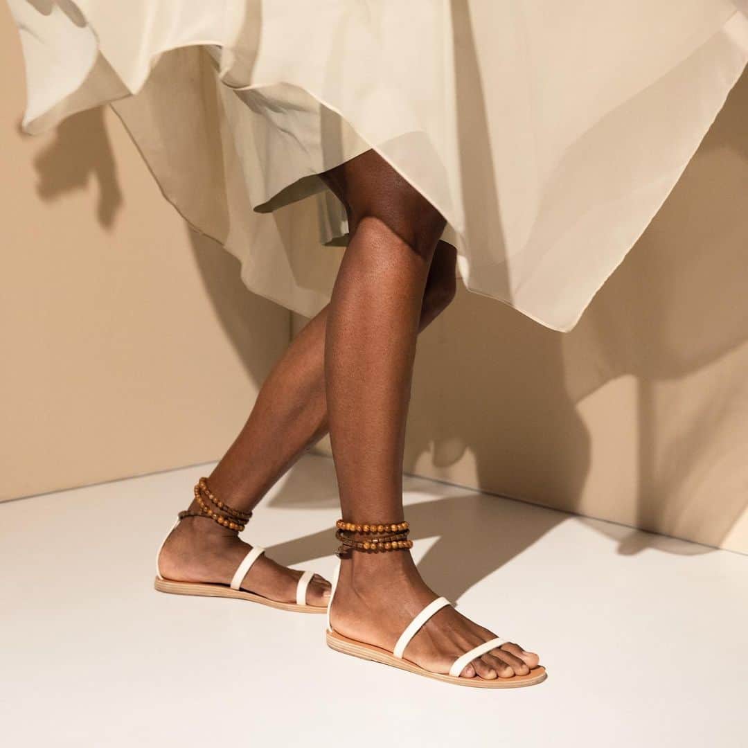 のインスタグラム：「Delicate beads decorate the ankle straps of our Smirni sandals 📿   📷 @yannisbournias  👗 @lazarostzovaras   #AncientGreekSandals #Ags #greece #handmadeingreece #sandals」