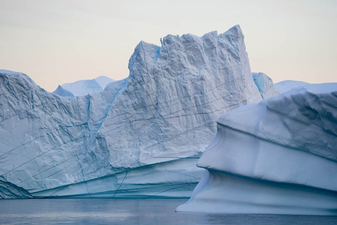 National Geographic Travelさんのインスタグラム写真 - (National Geographic TravelInstagram)「Photo by @mattborowick | When approaching an iceberg you have to be incredibly aware of your surroundings, as well as the depth of your boat. What we see above the water’s surface is only about 10 percent of its full size. These beautiful ice sculptures can be very dangerous if you get too close, so maintaining a safe distance is key. Conveniently for us, this iceberg was massive enough that we could see all the details in the ice—every scrape and fracture—from a reasonable range. Please follow for more pictures like these at @mattborowick. #iceberg #nature #greenland #arctic #sailing」4月25日 6時00分 - natgeotravel