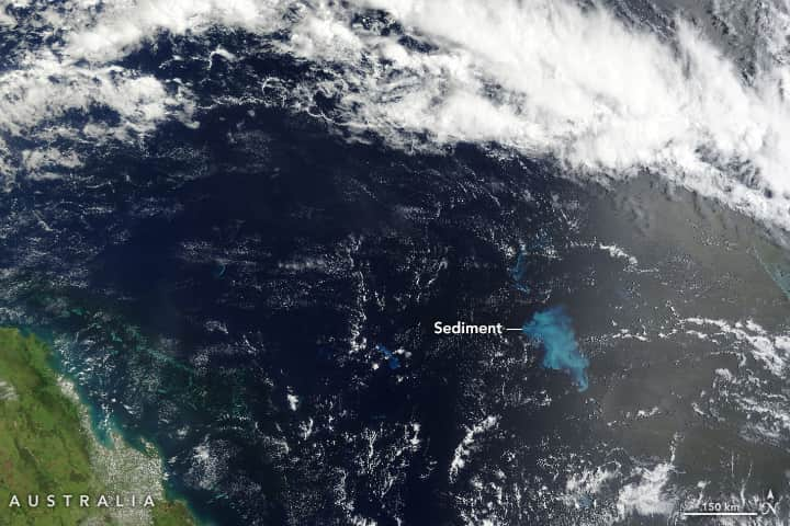 NASAさんのインスタグラム写真 - (NASAInstagram)「In February, Tropical Cyclone Gabrielle crossed the Coral Sea, off the coast of Australia, passing over the shallow Bellona Plateau.   The Bellona Plateau was a sizeable island during the Pleistocene ice ages but is now submerged under water. The plateau hosts a wide variety of marine life, including reefs and corals.   Gabrielle’s fierce winds stirred up enough carbonate sediment from the reefs to temporarily discolor 13,000 square kilometers of the water around the plateau.   Image Descriptions: Image 1: A satellite image of the ocean. The eastern coast of Australia is a jagged green mass that can slightly be seen in the bottom left corner. The ocean is a very dark blue, almost black, except for slightly right of the center point, where a clump of wispy, light blue sediment appears in the water. Clouds cover most of the top half of the image and are also scattered above the water.   Image 2: The same image as before, but significantly zoomed in. The background of the ocean is very dark blue, almost black. From the right of the image into the center is the light blue wispy sediment. At the edges of the main portion of sediment, it wanes off in wispier swirls and loops.」4月28日 0時02分 - nasagoddard