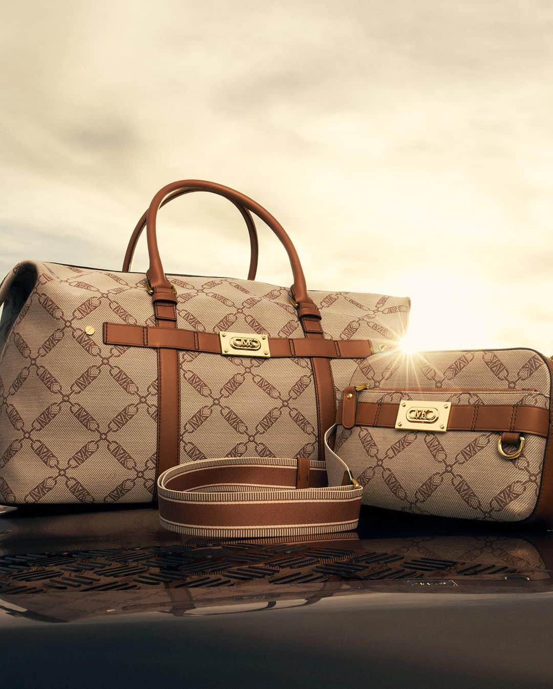のインスタグラム：「New Empire logo jacquard print luggage for spring. #MichaelKorsMens  Photographed by @MaximePoiblanc」