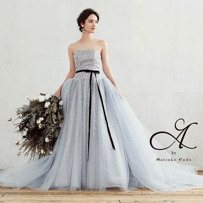 のインスタグラム：「*  ‐  Aurora / A by Hatsuko Endo ‐  ドレス全体に施されたビーズ刺繍が輝くロマンティックなドレス。  ローウエストにボリュームのあるオーバースカートを合わせることで スタイルアップされ、美しいシルエットを演出します。  ∇ご試着の予約はTOPリンクから >>> @tagayabridal_dress」