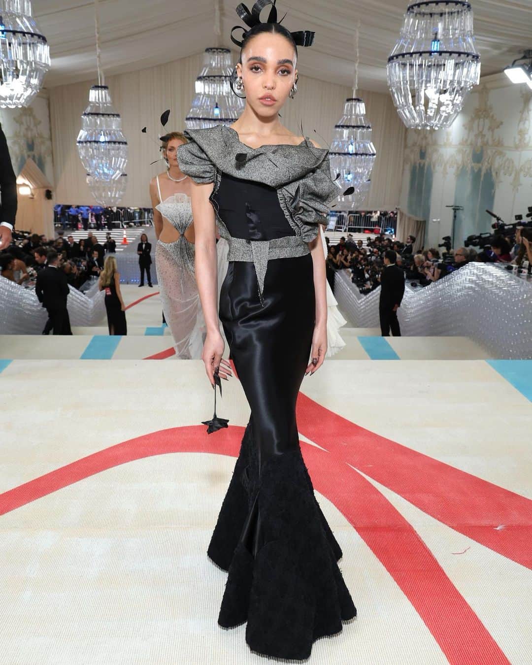 Maison Margielaのインスタグラム：「On the occasion of the Met Gala, @FKATwigs wore Maison Margiela Artisanal designed by @JGalliano from the Spring-Summer 2017 Collection.   FKA Twigs wore a Grey Harris tweed ruffle top paired with a bias-cut satin skirt with a keyhole tweed insert and black brocade platform mules.」