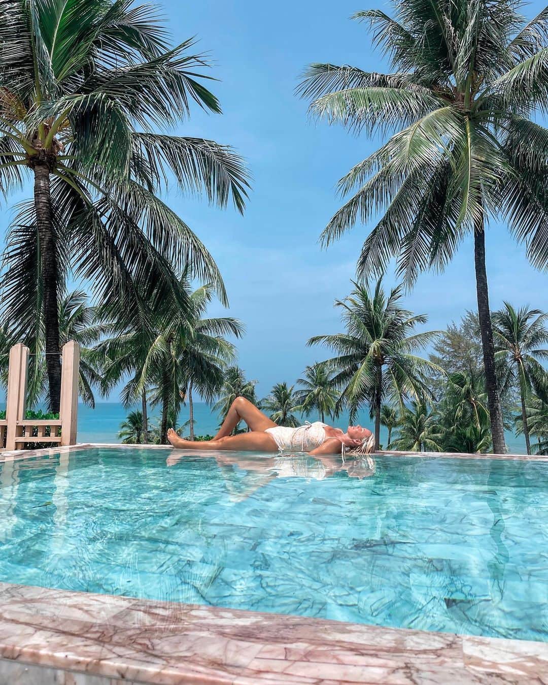 さんのインスタグラム写真 - (Instagram)「Floating on a cloud at @devasom_resorts 🩵 A must stay for your next trip to Khao Lak Thailand 🏝️  Which pic is your favorite? 1, 2, 3, 4…..10?  Here’s what we loved most -  ✨ Sustainability and social responsibility at the heart of everything they do. Every morning they do beach clean ups 👏 they provide nourishing school lunches to local children and employ the local community, creating a harmonious work environment that can be felt by all the guests 👏  ✨ The rooms are immaculate! And there are many types to suit varying budgets. We stayed in the Seaside Pool Paradise Suite and the Devasom Sky Penthouse villa. We loved the Sky Villa’s expansive views and space, the long infinity pool, steam room and spa. The views from the Seaside suites are equally impressive overlooking the ocean and lagoon. Beds were so luxurious and comfortable in both and we slept so deeply every single night 😴   ✨ The food! The delicious vegan food! 👏 The menu had many amazing options. There are 2 restaurants - Takola, which is traditional Thai food, and the Beachfront Restaurant which is western cuisine. We loved them both but I can’t go past Thai food when in Thailand. It’s just so good 🌶️   ✨ There is so much to do at the resort - complimentary stand up paddle boarding and kayaking in the lagoon, forest bathing, eco cycling tours, yoga and meditation in the lagoon tower, a day spa with the best Thai treatments you’ll ever have, and a shuttle bus that can take you to town and back. Take a complimentary bike and explore local villages, temples and the coconut mangroves. There’s also a stunning main pool with beach and pool lounges, a beach bar and restaurant for food/cocktails/mocktails. They can even set up a beautiful beach sunset picnic or private group dining experience for you 🌅   This was the most fantastic week in Thailand, rich with adventure, fun, yummy food and relaxation. My favorite combination. I highly recommend Khao Lak and @devasom_resorts for your next Thailand travel experience 🏝️  #devasomkhaolak #penthouse #luxuryresort #visitthailand #thailand #amazingthailand #beautifulhotels」5月29日 19時38分 - helen_jannesonbense