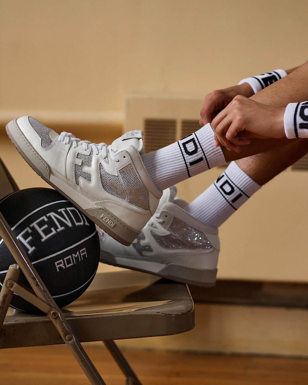Fendiのインスタグラム：「An exclusive iteration of the #FendiMatch sneaker embellished with rhinestones completes the Fendi Active Basketball Capsule.  Shop the edit including a limited-edition basketball made in collaboration with @spalding at Fendi.com.  Artistic Director of Accessories and Menswear: @silviaventurinifendi  Artistic Director of Jewelry: @delfinadelettrez  Photography: @brunostaub  Styling: @ganio Makeup: @makiryoke Hair: @jimmypaulhair Set Design: @mattjacksonmattjackson  Casting: @piergiorgio  Model: Daylan Vermilyer」