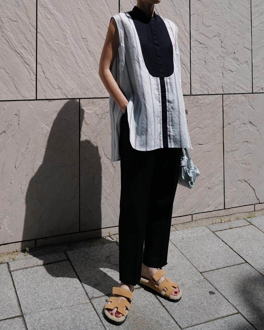正中雅子のインスタグラム：「異素材切替デザインのヨークシャツ☺︎  ストライプ生地は、トルコメーカーのものでサスティナブル素材🇹🇷 やはりインポートの柄って他になくて一目惚れしたもの🫶  柔らかなストライプの生地と裏腹に、しっかりしたピケ素材の凹凸がある生地でヨークを作りシルバーピンを付けてシャキッとした印象に📍  着心地良くて夏に活躍間違いなしです！  そして！ PRE ORDERでも大人気だったテーパードPTが入荷します！！  お見逃しなくです！  後半の写真は、 お気に入りのシャーリングシリーズのBLKにバルーンスカートを合わせたオールブラックスタイル🖤  ブラックにはアイボリーボタンなのもアクセントになっています！  8.10 wed  12:00 in stock!」