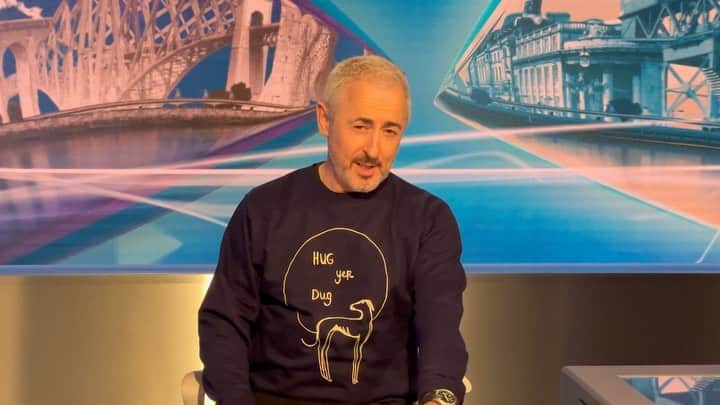 アラン・カミングのインスタグラム：「Today @forbesmasson and I snuck in to the @stvnews studio in Glasgow and pretended to be newsreaders, and also visited the scene of our former crimes across the Clyde at the Finneston Crane. And I got the chance to model my new @floredehoog sweatshirt! Goodbye Glasgow, it was quick but it was fun - the perfect combo!」