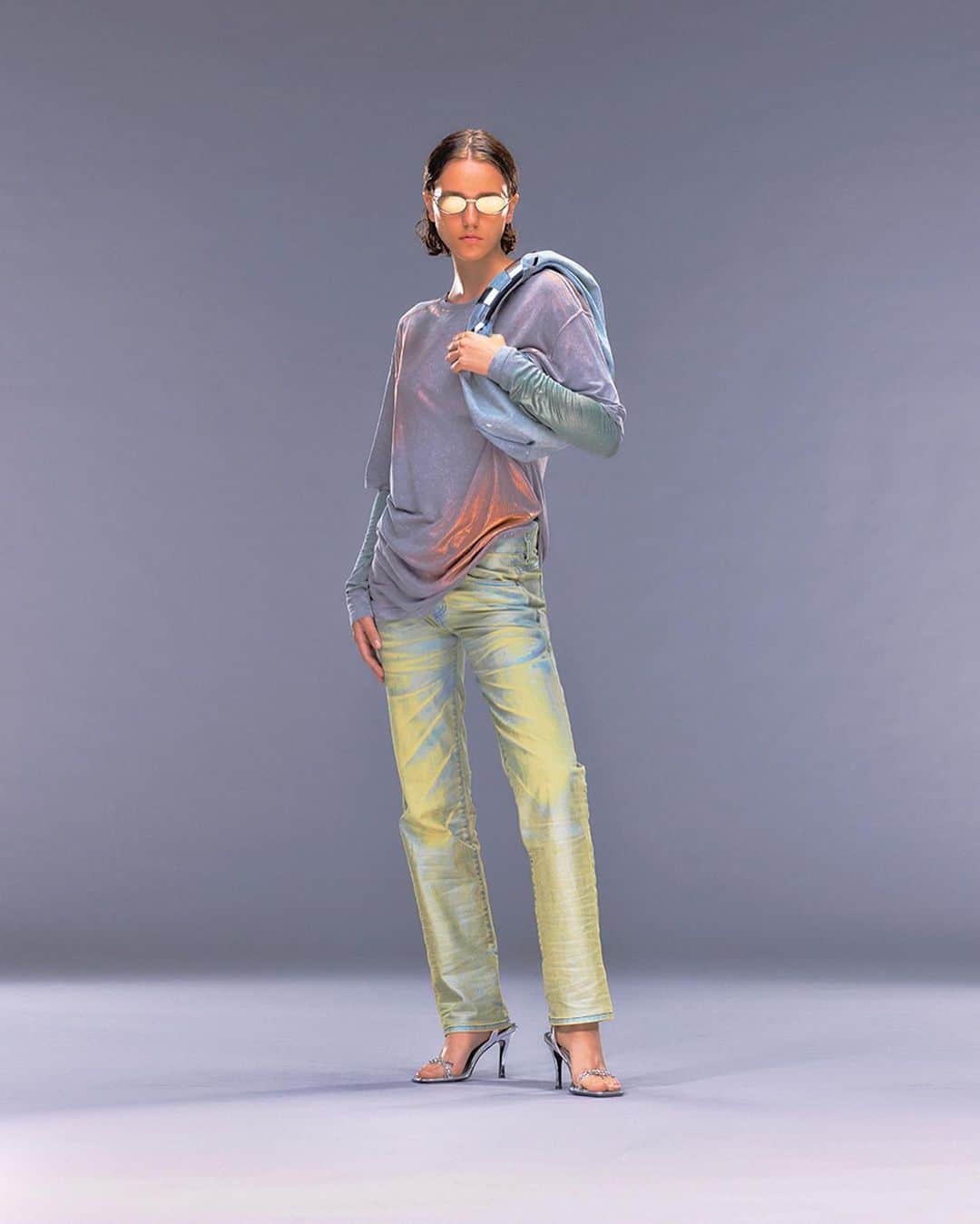 ディーゼルのインスタグラム：「Reflective energy.   For #DieselPreSpring24, Creative Director @glennmartens infused the casual side of the Diesel vocabulary with a reflective glow. Jersey T-shirts, hoodies and denim are coated to create a rainbow mirror effect that shows a spectrum of colors.   Photographer: @jack_bridgland_studio  Styling: @ursinagysi   Read the review and see the full Pre-Spring 2024 collection on @voguerunway at the link in bio.   #ForSuccessfulLiving」