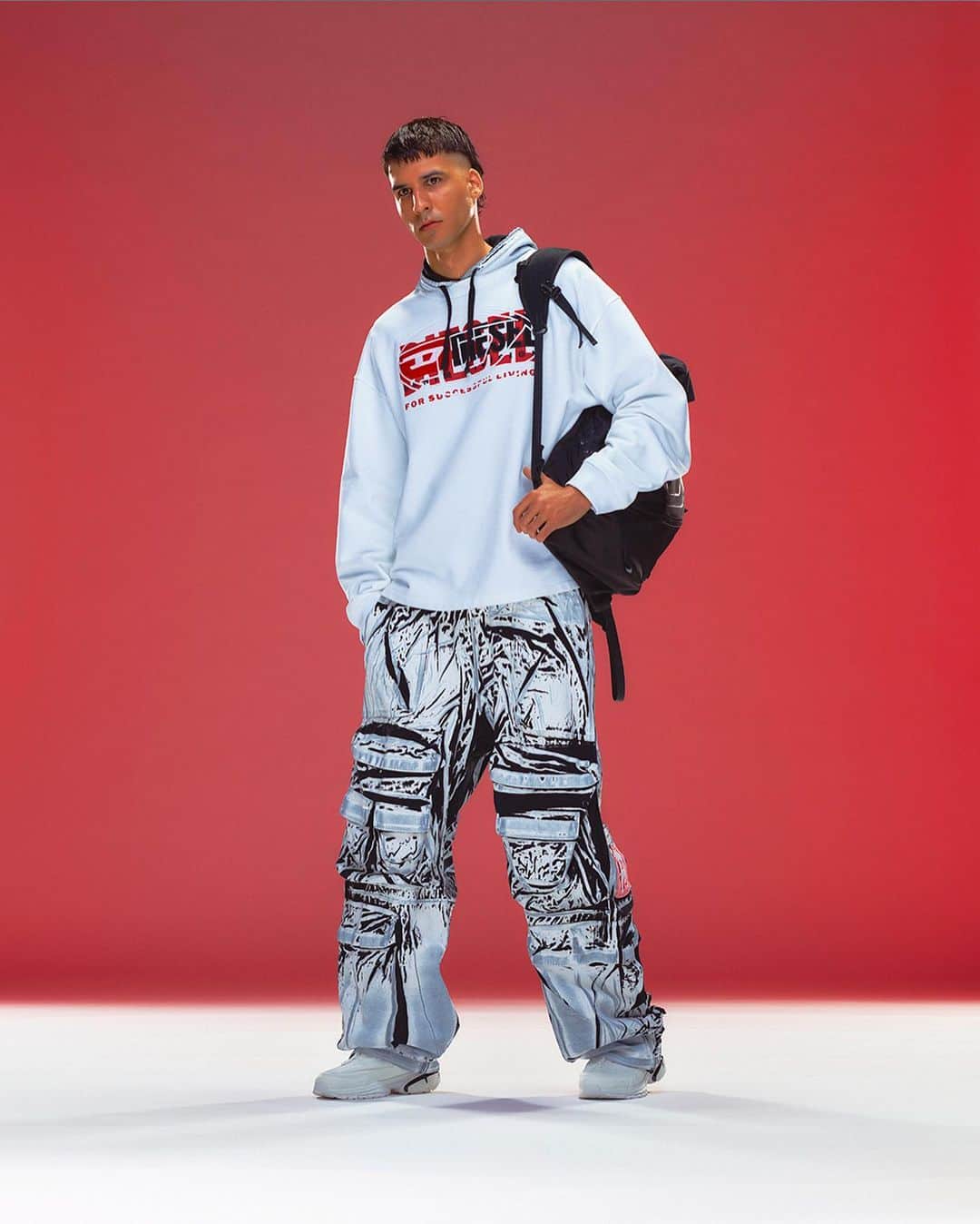 ディーゼルのインスタグラム：「Experimentation for everybody.   Creative Director @glennmartens pushes the creativity and experimentation of his runway collection in pieces that are easy to wear for #DieselPreSpring24.   New treatments of the Diesel logo are layered on top of each other on oversized hoodies and bandeau tops. The monster cargo pants that have become a signature in recent seasons are amplified in new treatments and silhouettes, and black leather biker jackets, pants and boots feature new applications of the Oval D hardware logo.   Read the review and see the full collection on @voguerunway at the link in bio.   #ForSuccessfulLiving」
