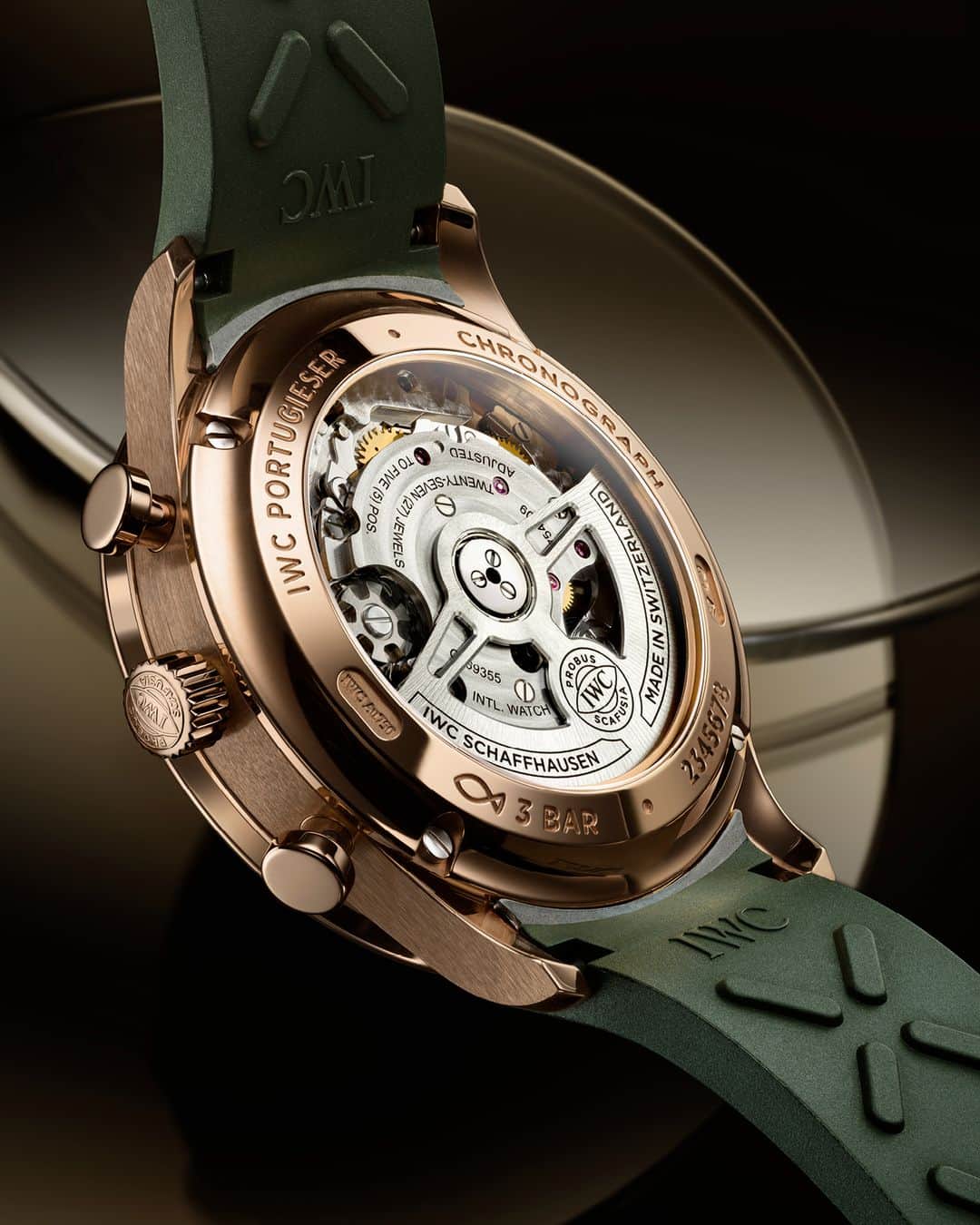 IWCのインスタグラム：「The IWC-manufactured 69355 calibre is the powerhouse behind our #IWCportugieser Chronograph (Ref. IW371611) shown with an olive green rubber strap. Visible through the sapphire-glass case back, this precise chronograph movement has a classic pawl system that winds on both sides. Visit your IWC boutique or retailer to discover the variety of strap options available. #TheReference  🔗Link in Bio」